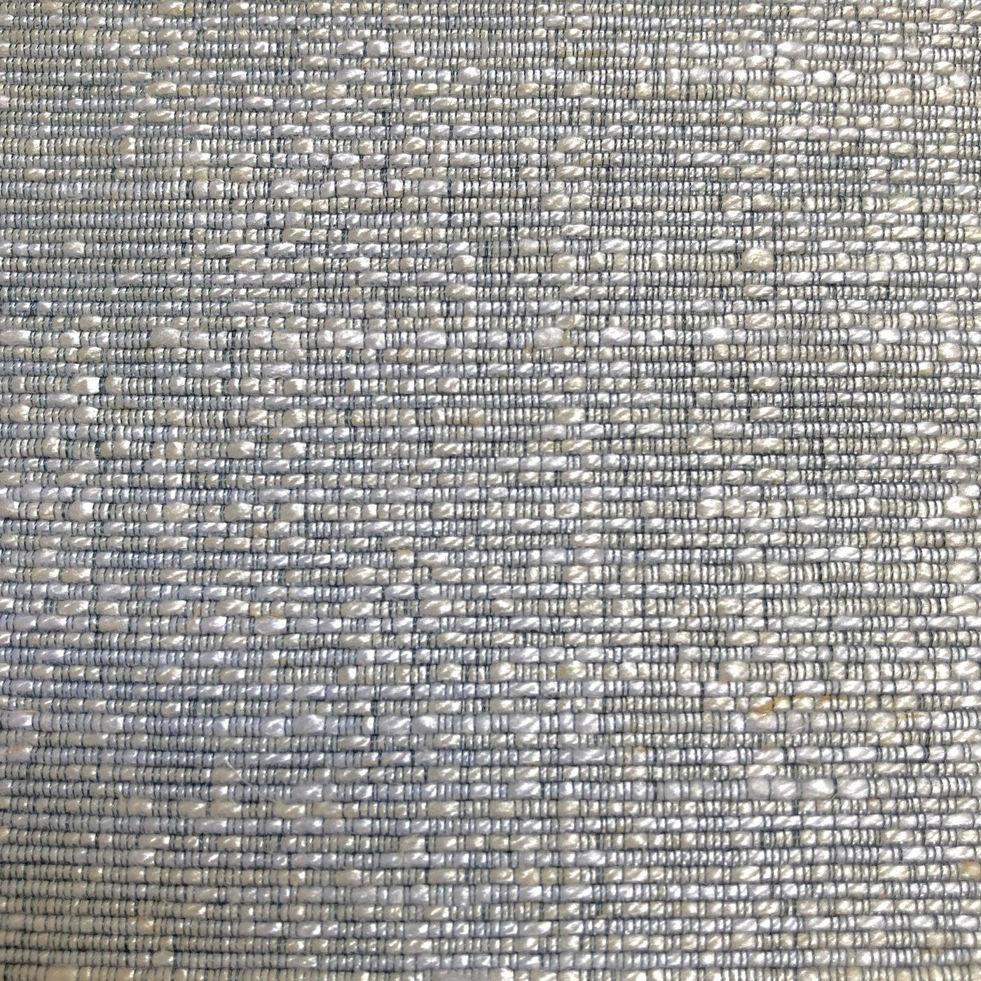 Close-up of Ann Gish Isla duvet cover weave texture in silvery blue and ivory.