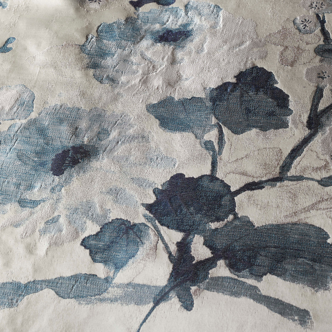Close-up of Ann Gish Jardin Fleur duvet cover showing navy and slate blue floral print on ivory linen.