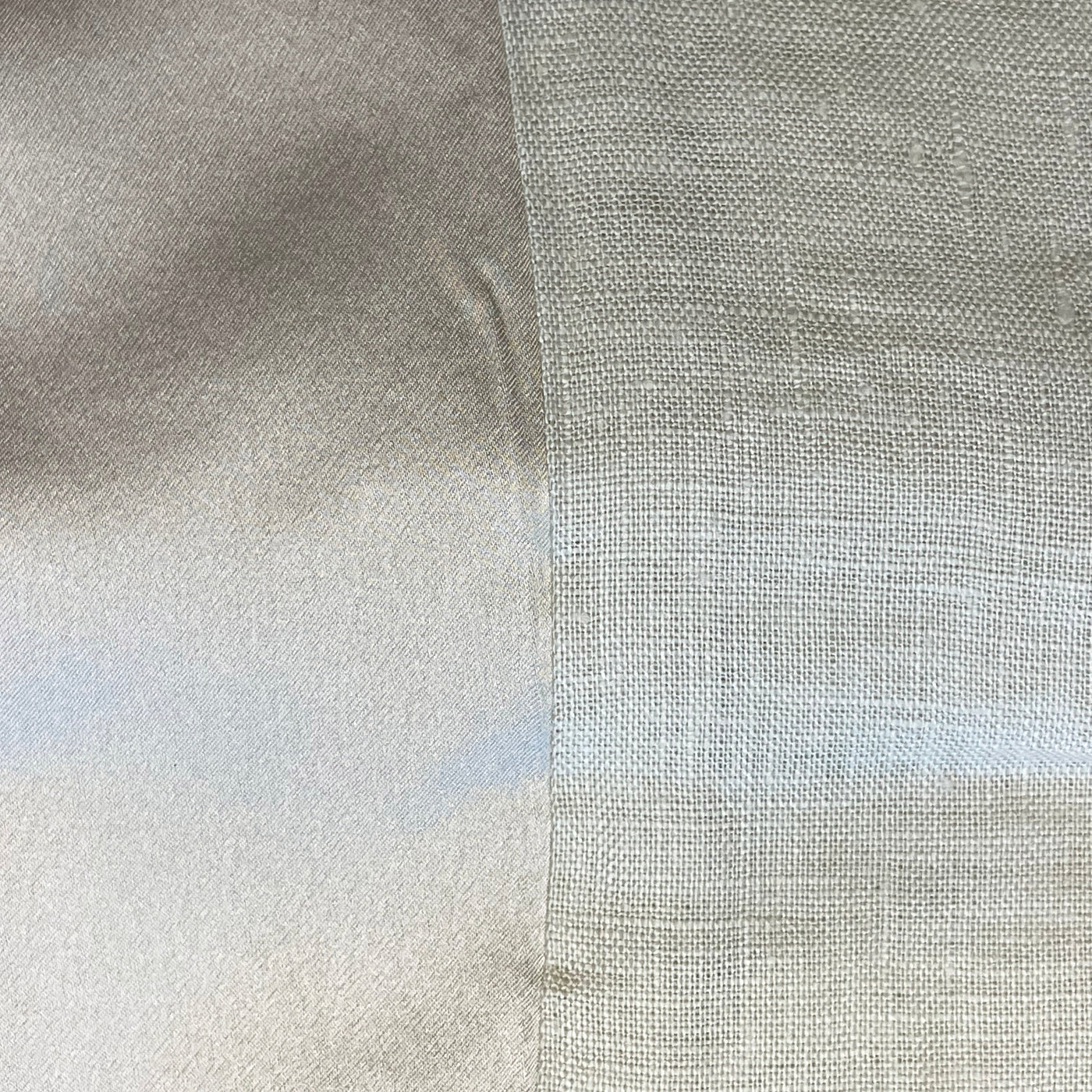 Side-by-side close-up of satin and open-weave linen fabric panels in silver-grey.