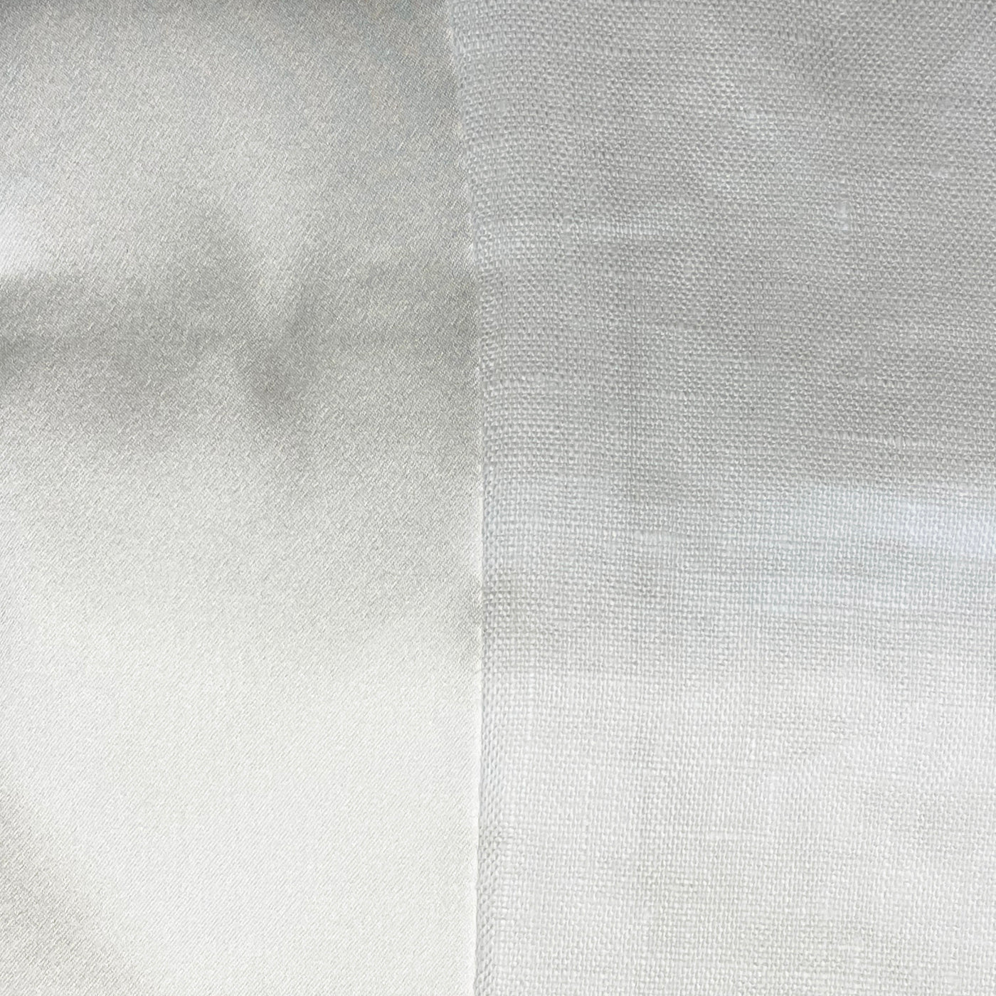 Close-up of two white fabric panels showing contrasting weave textures side by side.