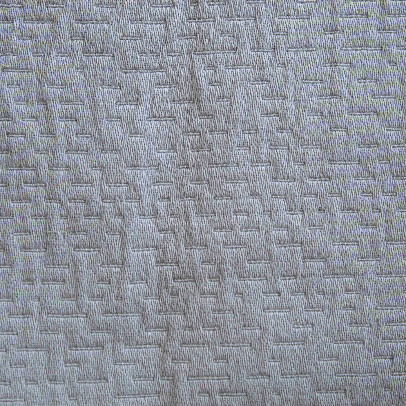 Close-up of Ann Gish Neo duvet set fabric, showing silver geometric woven texture detail.