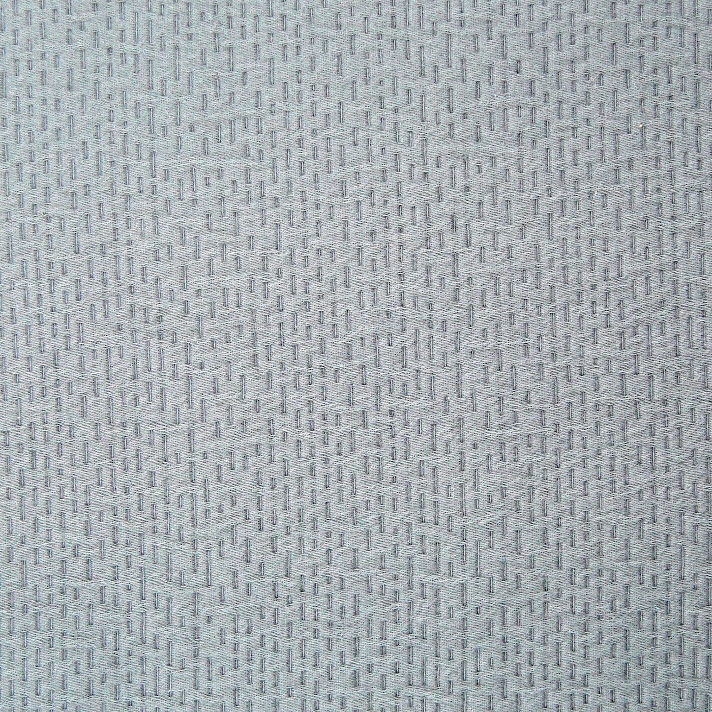 Close-up of Ann Gish Neo matelasse weave texture in pale silver-blue.