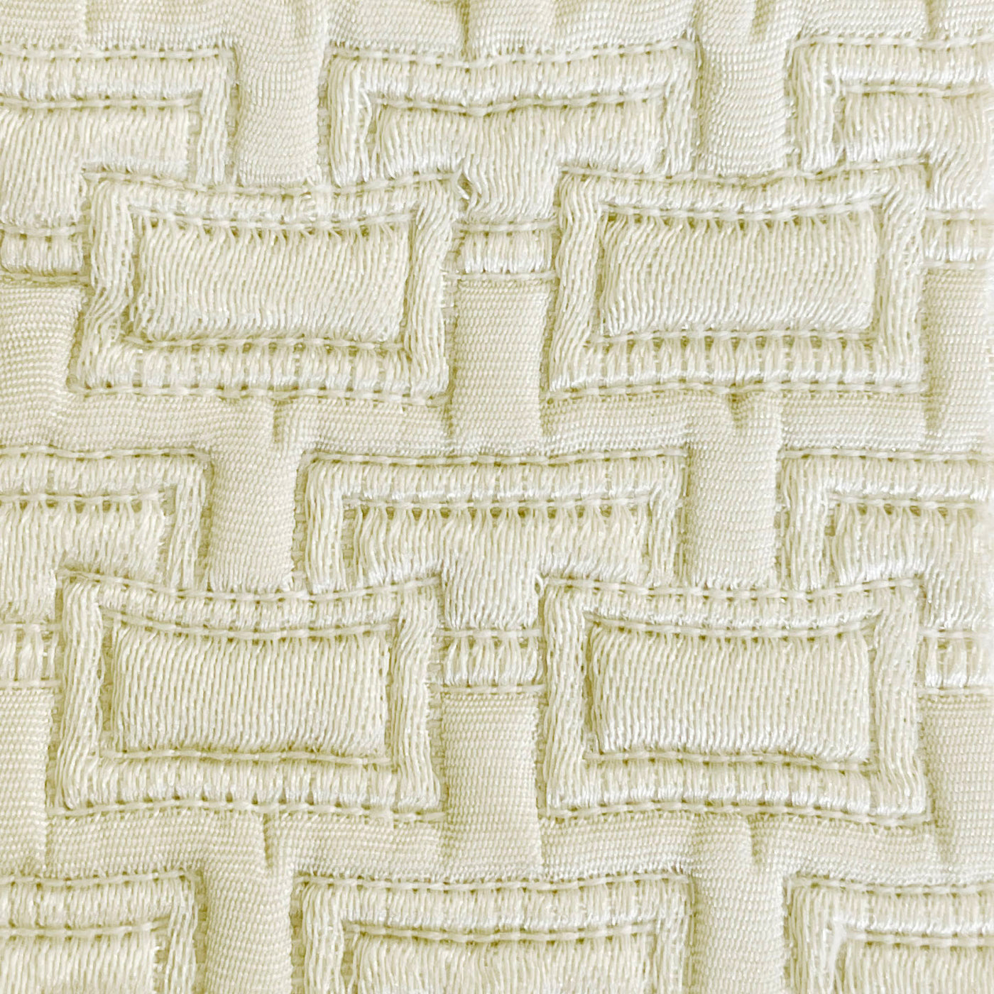 Close-up of ivory woven geometric rectangle pattern on Ann Gish Pavilion pillow fabric.
