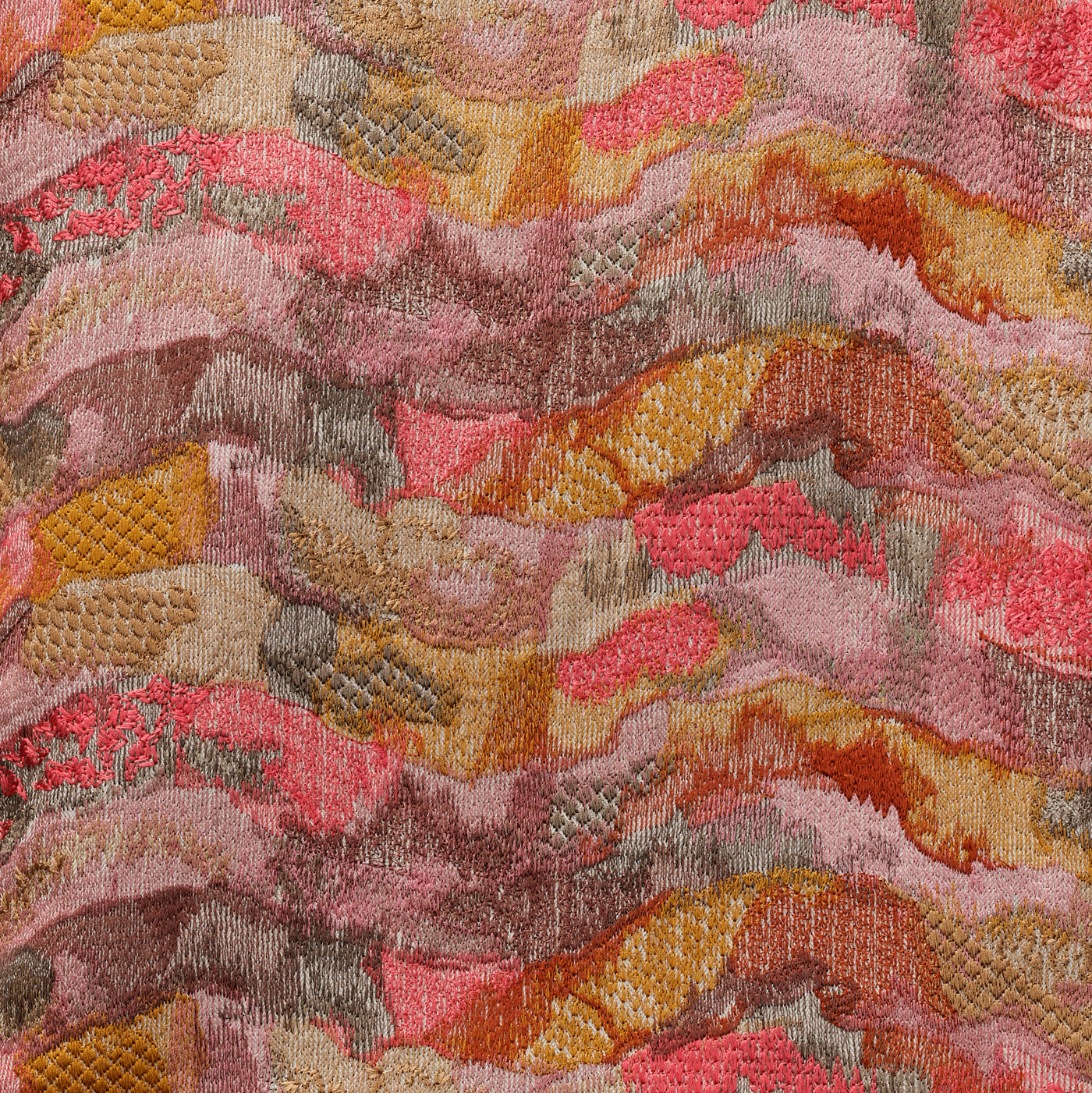 Close-up of Ann Gish Positano pillow fabric in coral, amber, and rose wave pattern.