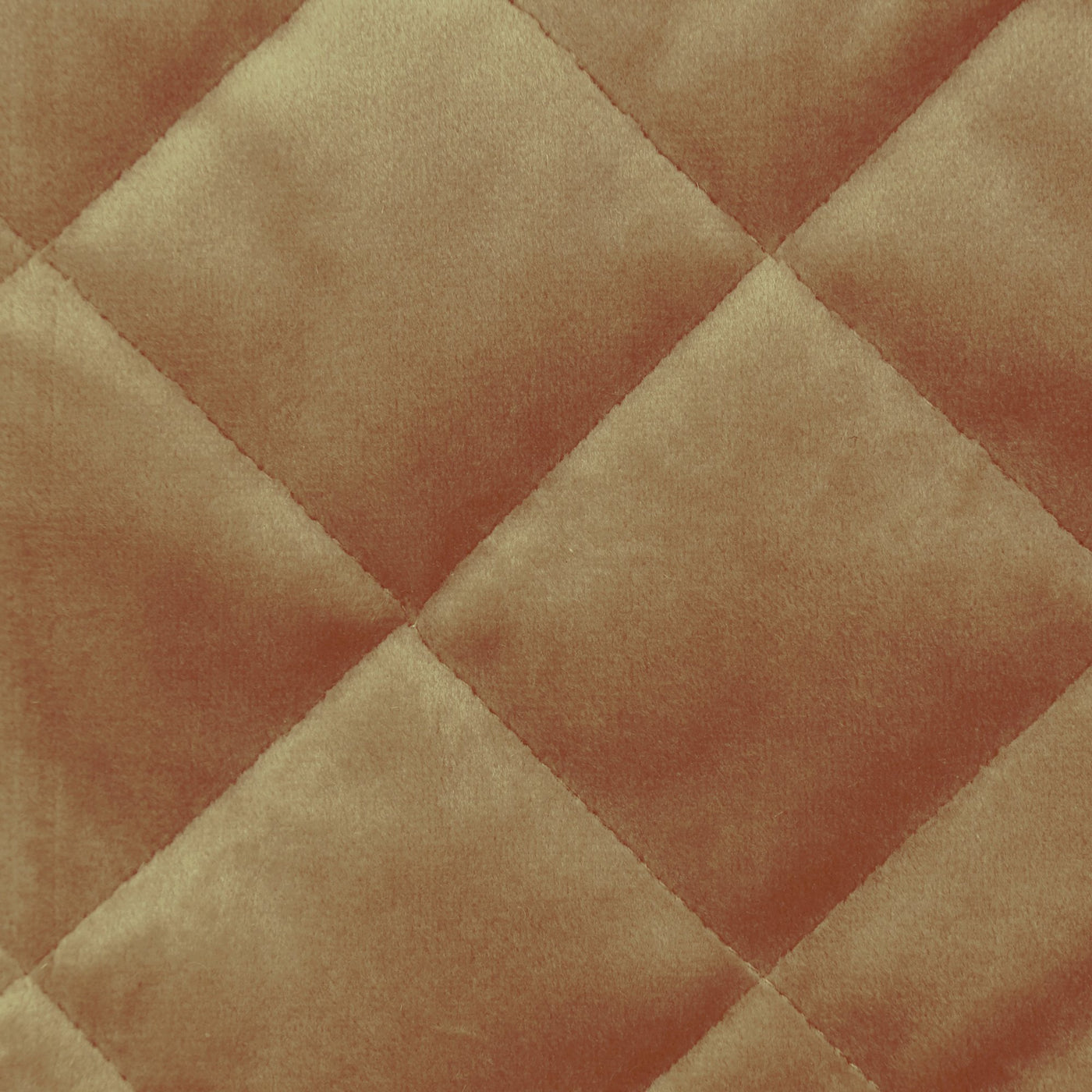 Close-up of Ann Gish Velvet coverlet in caramel, showing diamond quilting detail.