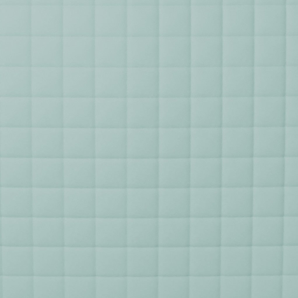 Close-up of Ann Gish Ready-to-Bed 2.0 coverlet showing seafoam quilted grid stitching detail.