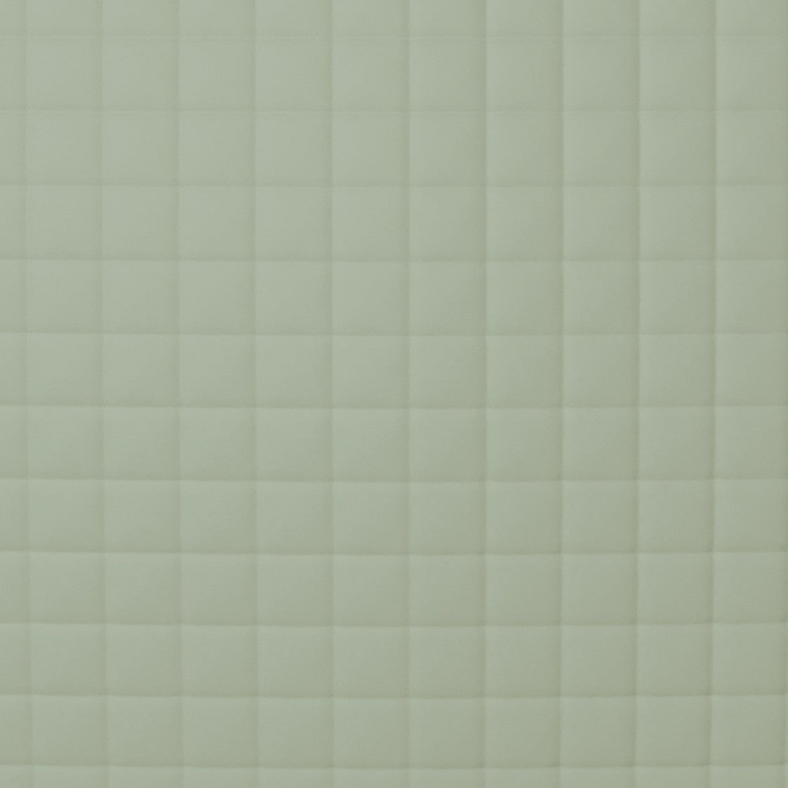 Close-up of sage quilted grid stitching on Ann Gish Ready-to-Bed 2.0 coverlet.