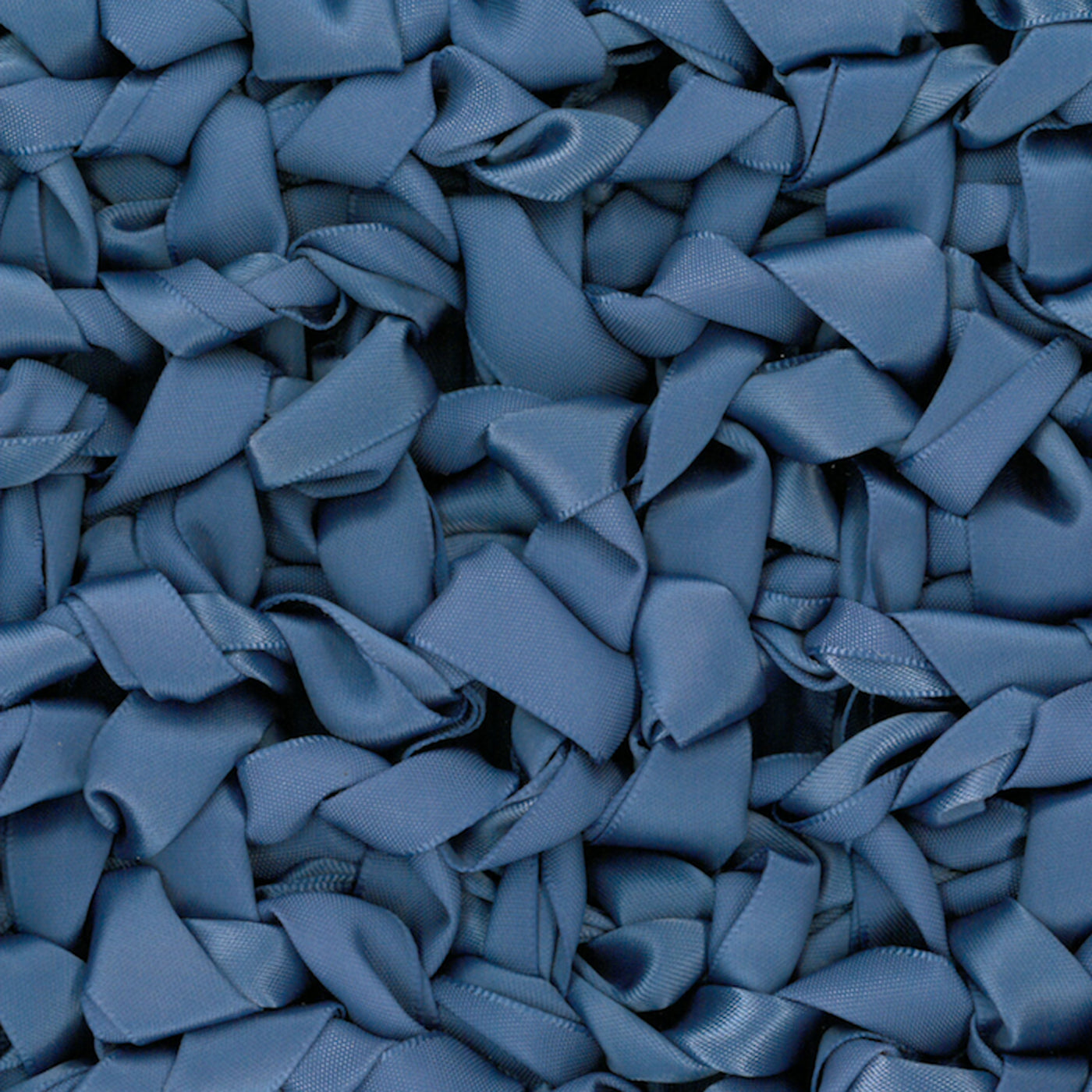 Close-up of Ann Gish Ribbon Knit Pillow in slate blue, densely layered satin ribbon loops.