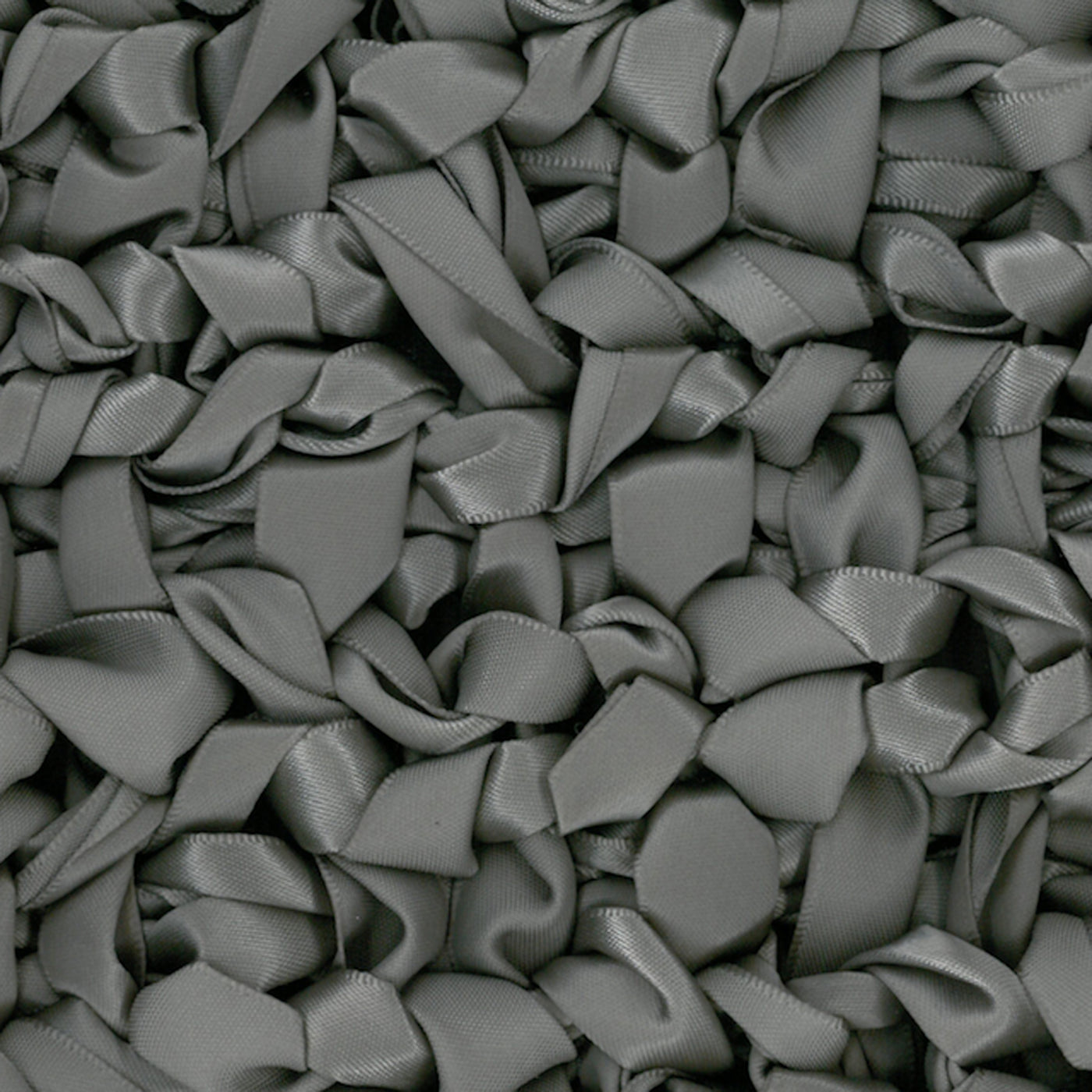 Close-up of Ann Gish Ribbon Knit pillow surface in slate grey satin ribbon loops.
