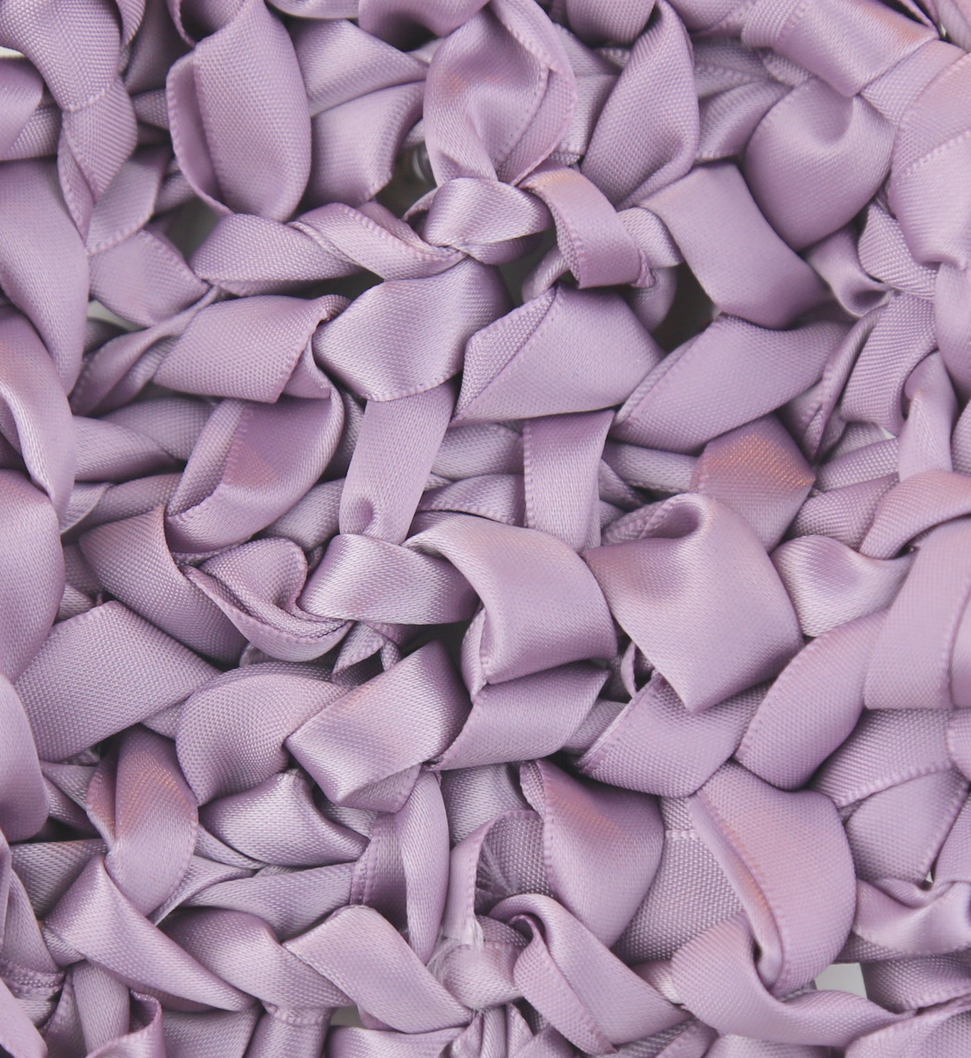 Close-up of Ann Gish Ribbon Knit Pillow surface in lavender satin ribbon loops.