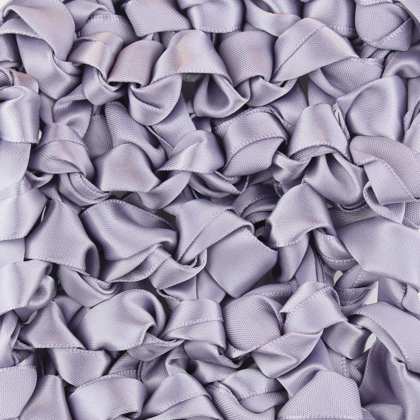 Close-up of lavender satin ribbon loops forming a ruffled texture on Ann Gish pillow.