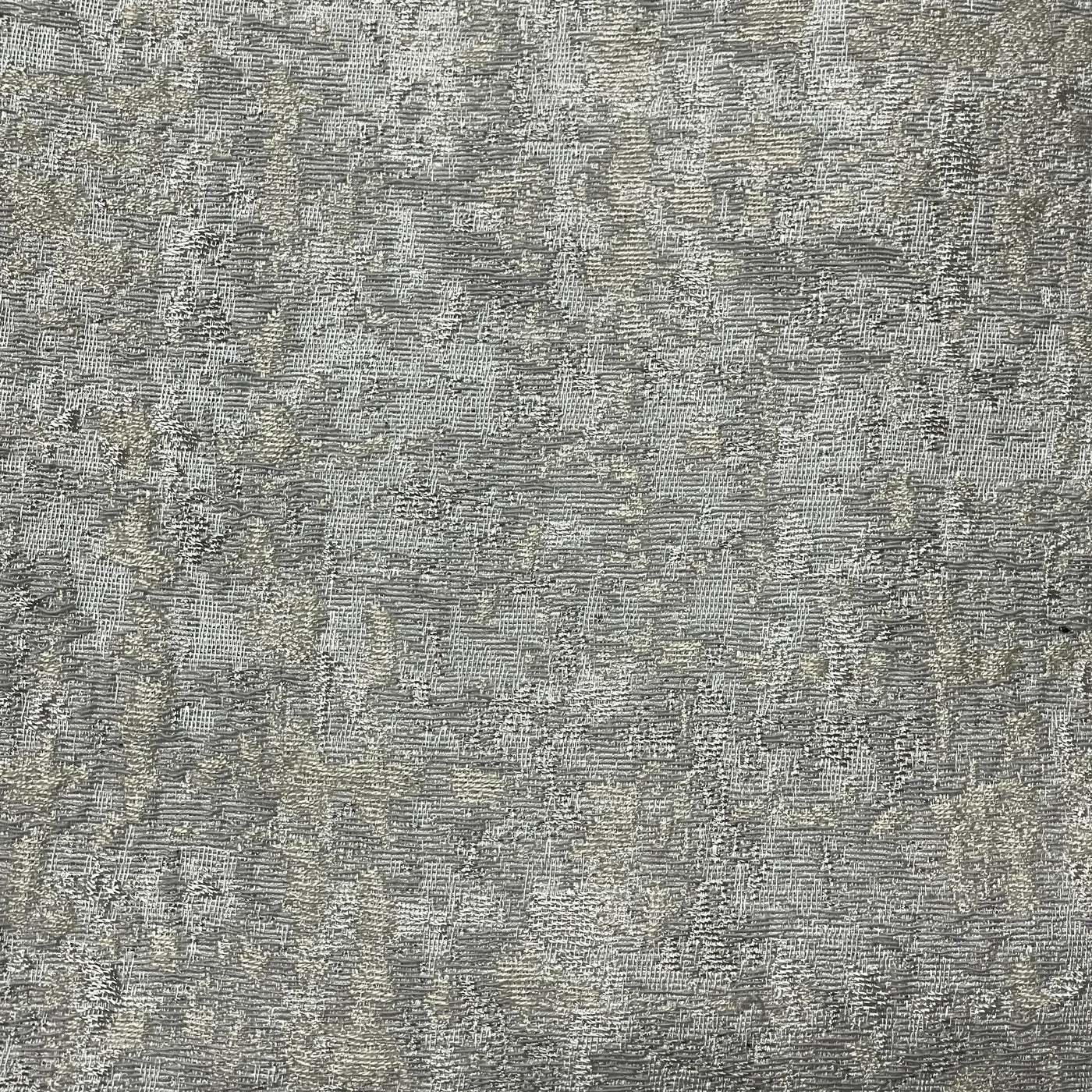 Close-up of Ann Gish Serac duvet cover fabric in silver-grey with mottled texture.