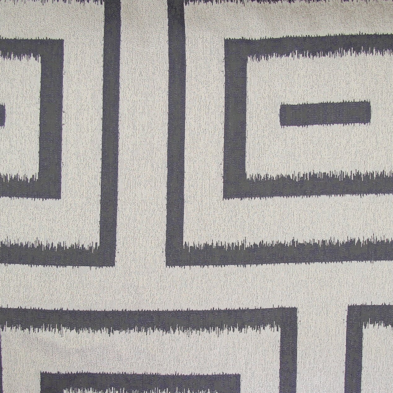 Close-up of Ann Gish Unmazed duvet cover fabric, charcoal Greek key ikat pattern on ivory.