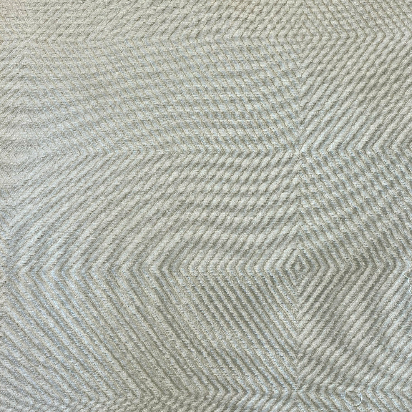 Close-up of Ann Gish Vector coverlet showing sage geometric diamond weave texture.