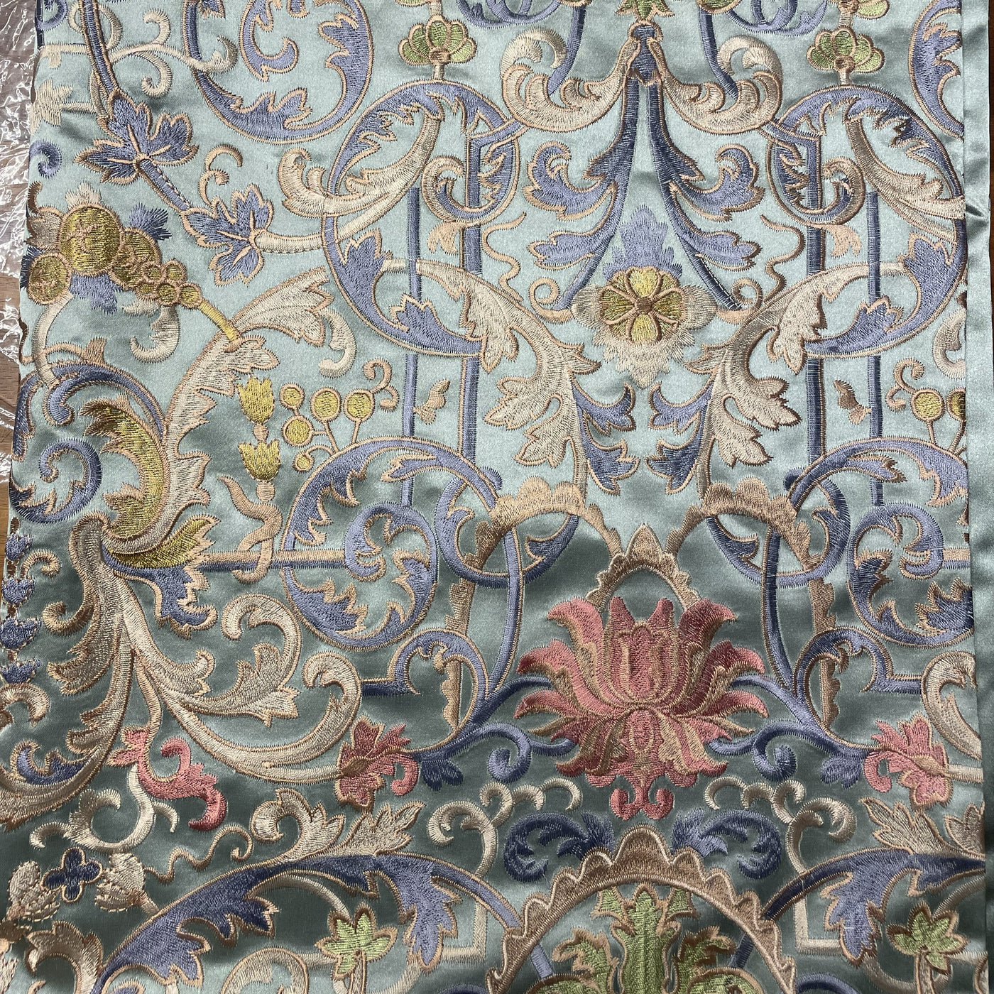 Close-up of Ann Gish Venezia duvet cover showing intricate baroque floral embroidery in sage, blue, and rose.