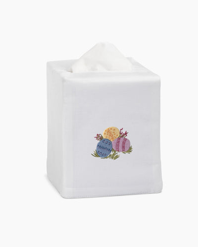 Henry Handwork white linen tissue box cover with embroidered Easter eggs in blue, yellow, and pink.