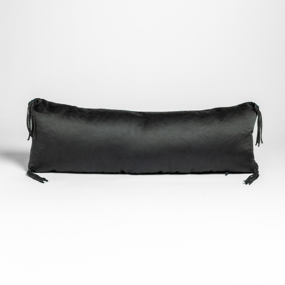 Corvino Taline throw pillow, long lumbar silhouette with tassel tie ends.