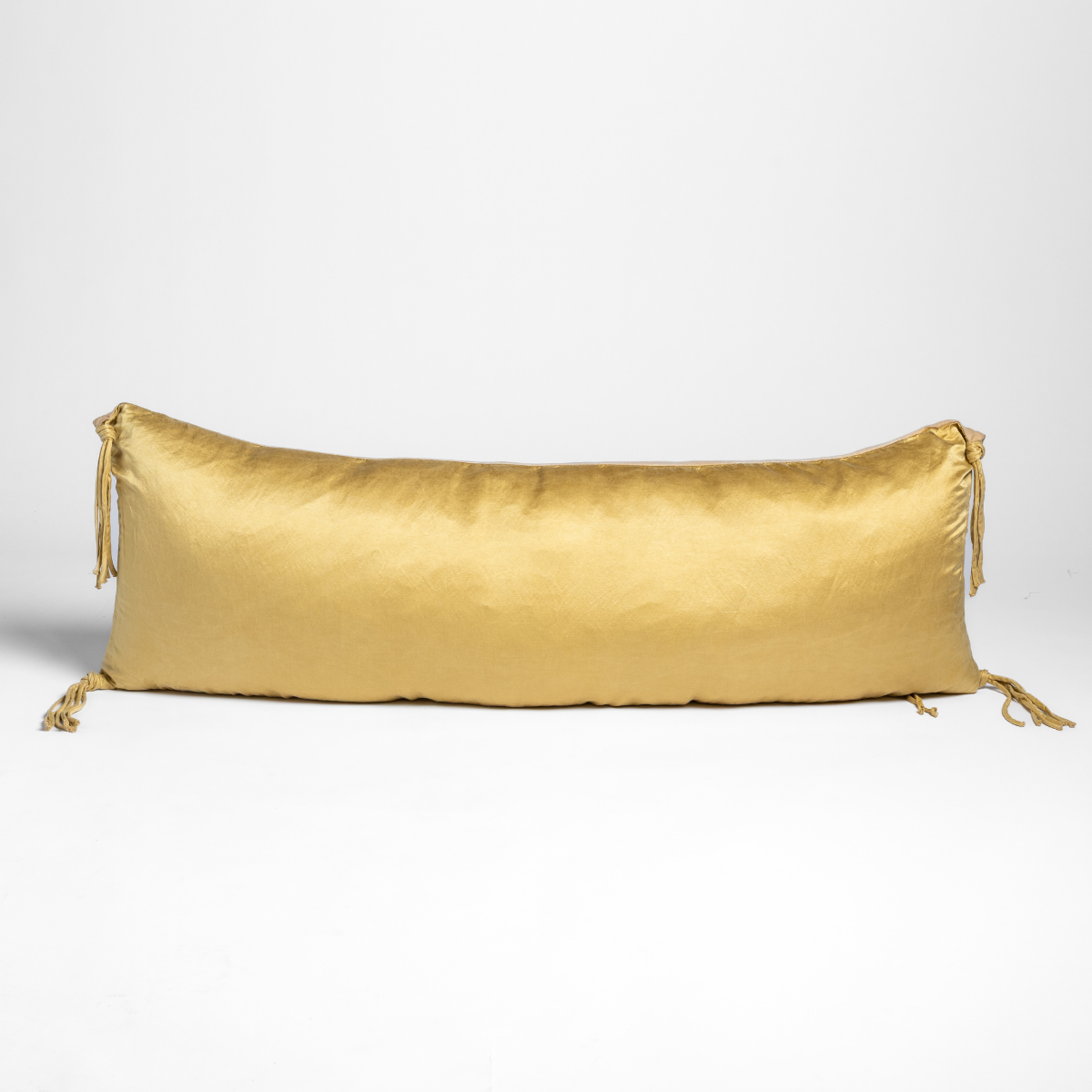 Honeycomb lumbar throw pillow with silky sheen and tassel ties at both ends.