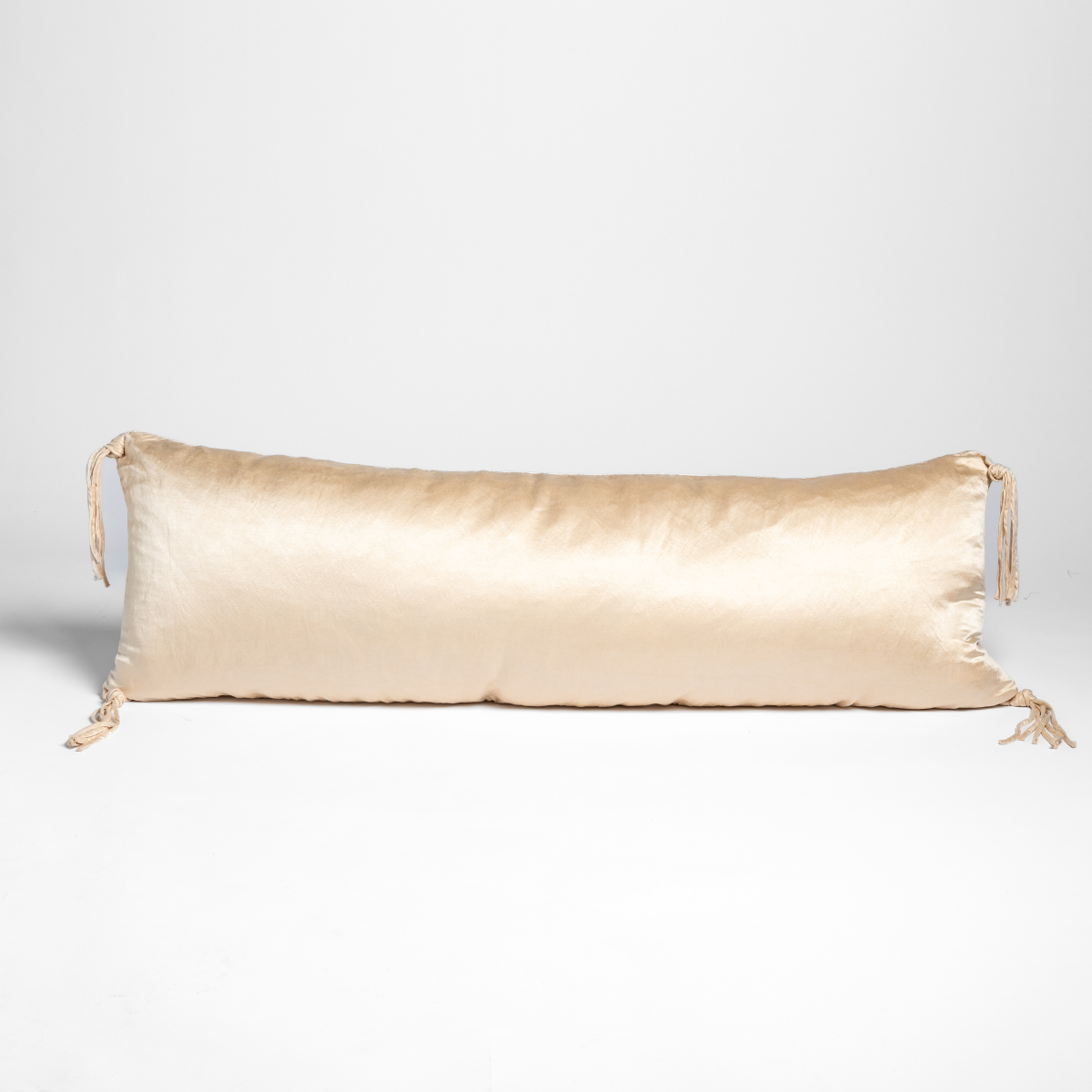 Bella Notte Taline throw pillow in Pearl, elongated bolster with tassel ties at each end.