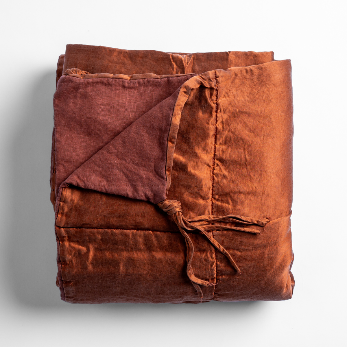 Bella Notte Taline blanket in Autumn, folded flat showing ribbon ties and linen texture.