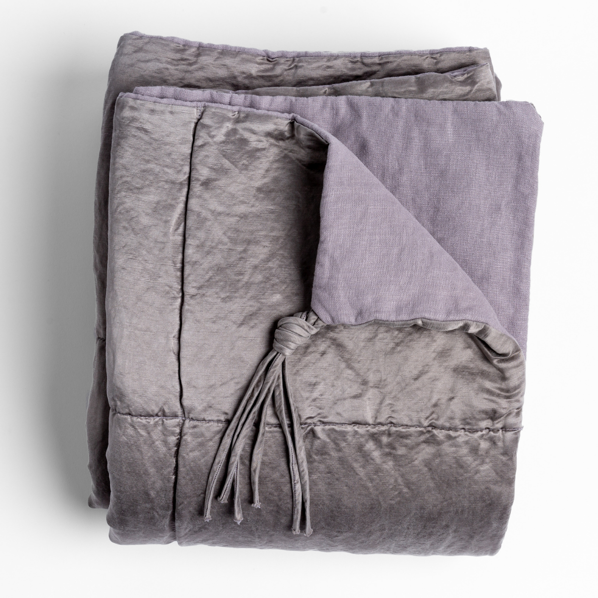 Folded French Lavender Bella Notte Taline blanket showing tassel tie detail.