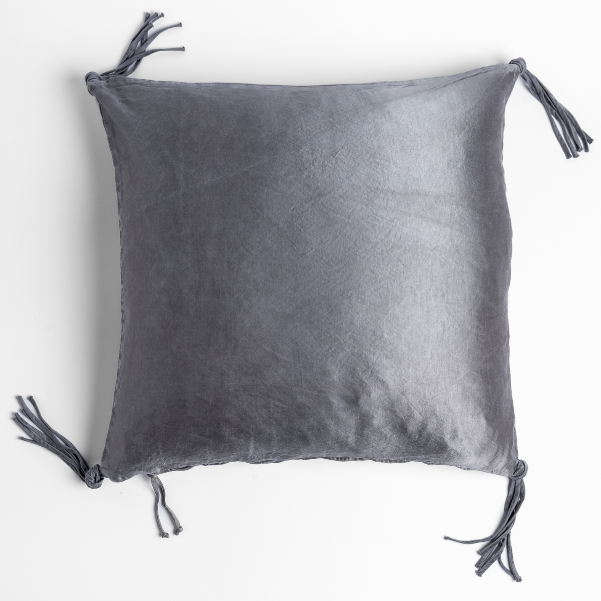 French Lavender velvet throw pillow with corner tassels, flat lay view.