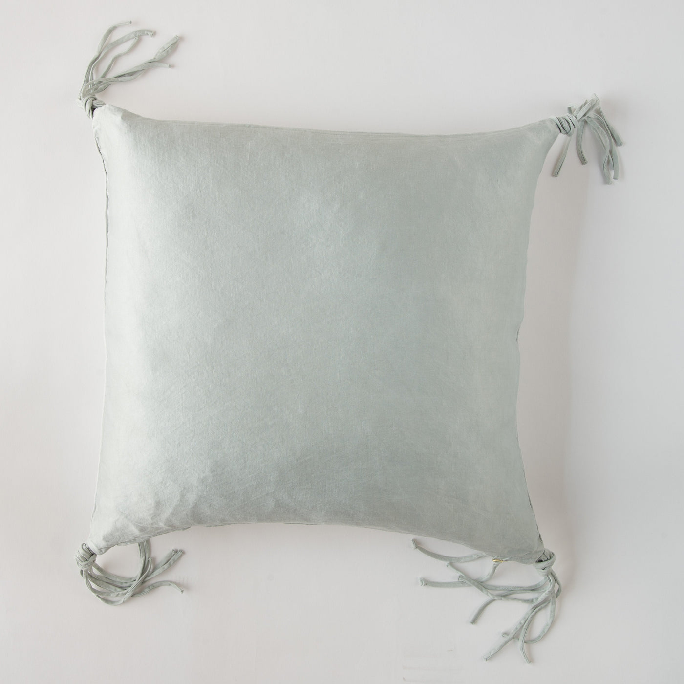 Bella Notte Taline throw pillow in Cloud, showing knotted tassel corners against a white background.
