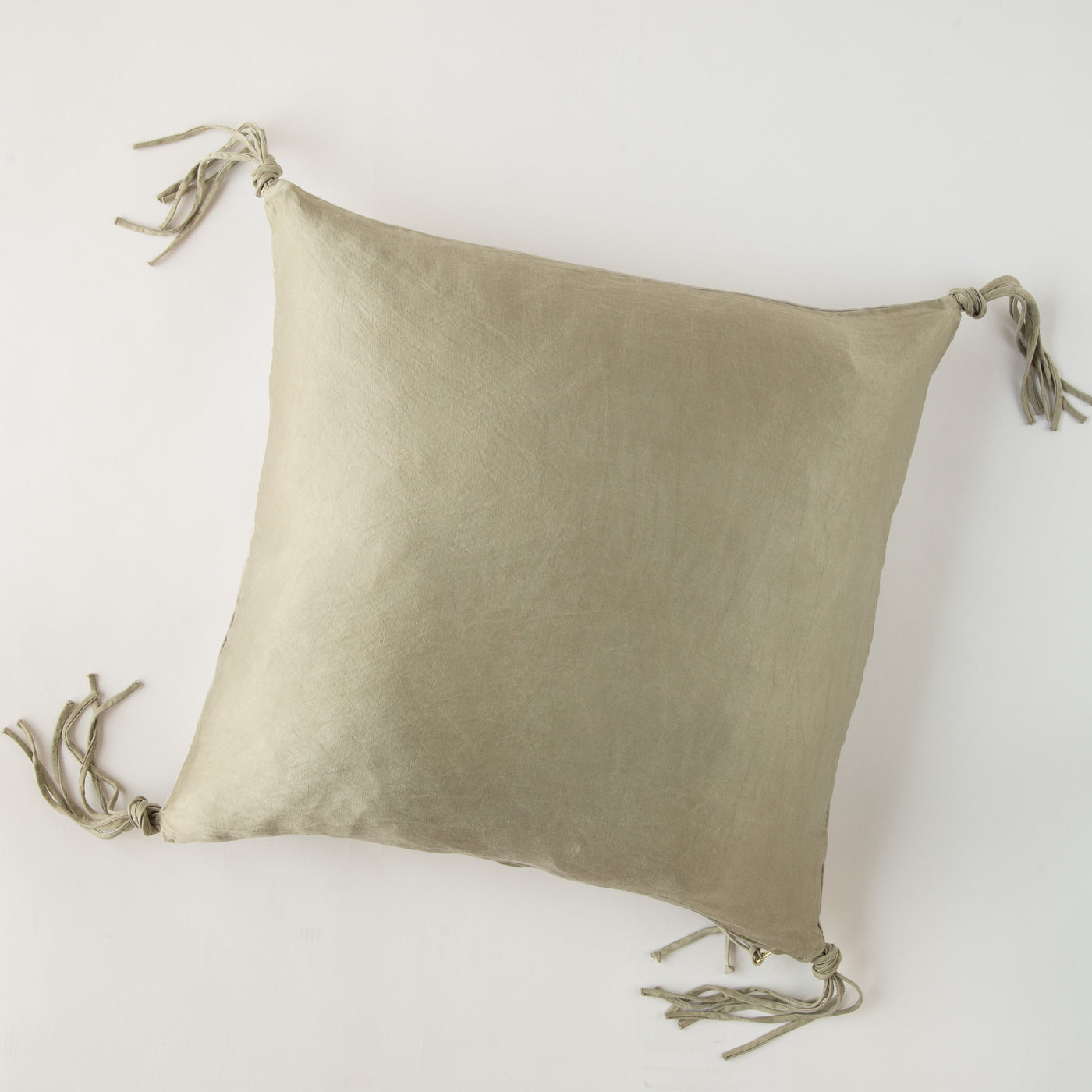 Fog linen throw pillow, back view showing corner tassel ties against white background.