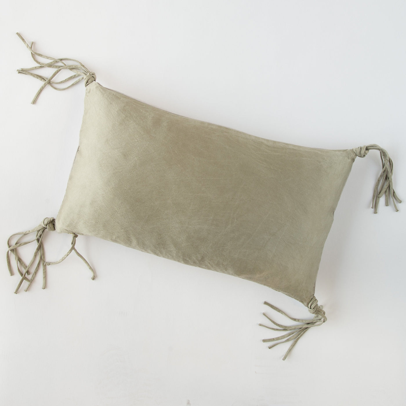 Bella Notte Taline throw pillow in Fog with knotted tassel corners on white background.