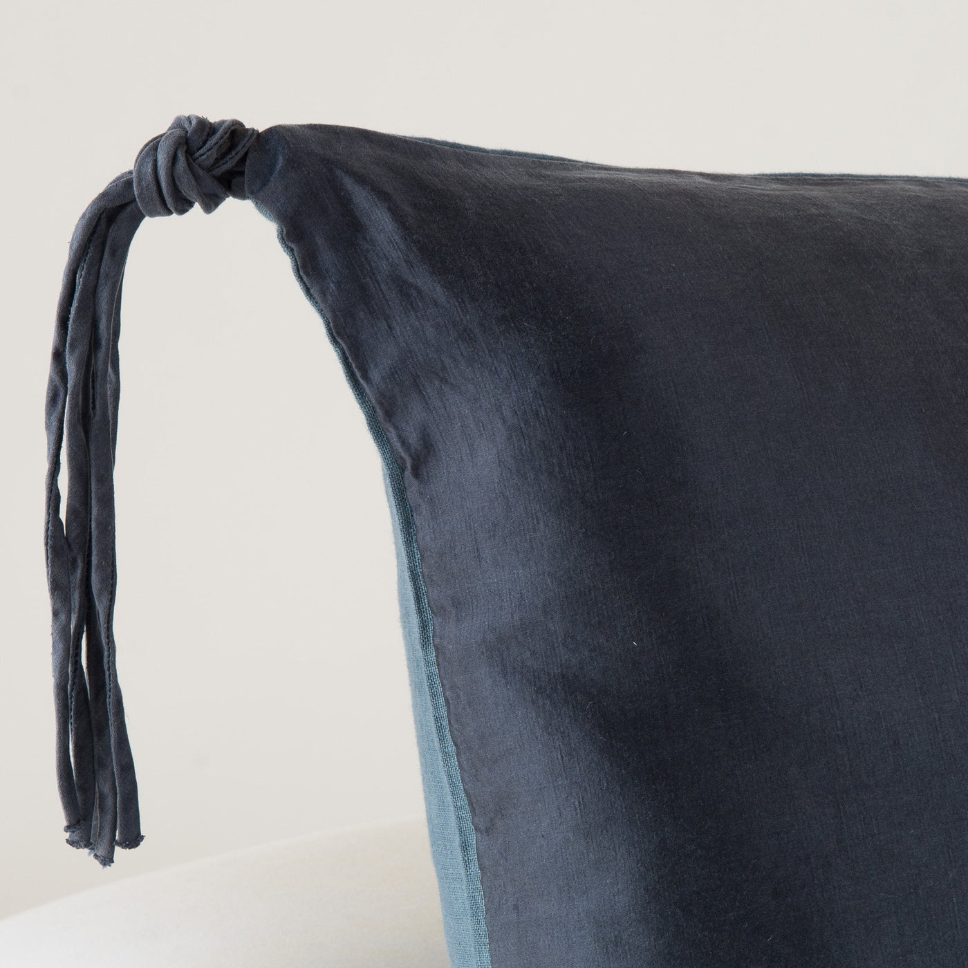 Close-up of Bella Notte Taline sham corner detail with knotted tassel tie in Midnight.