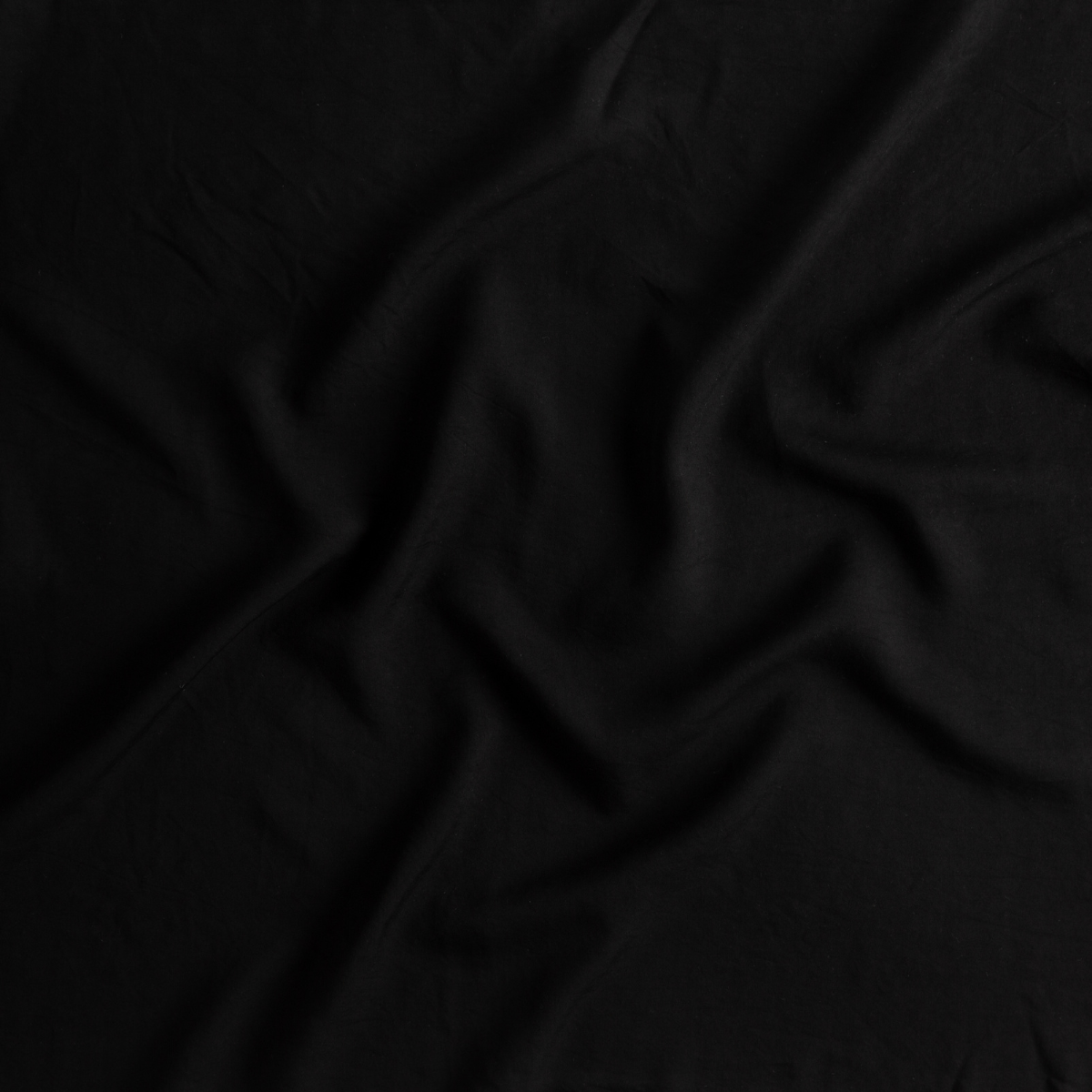 Close-up of Bella Notte Madera Luxe crib sheet in Corvino, showing draped fabric texture.