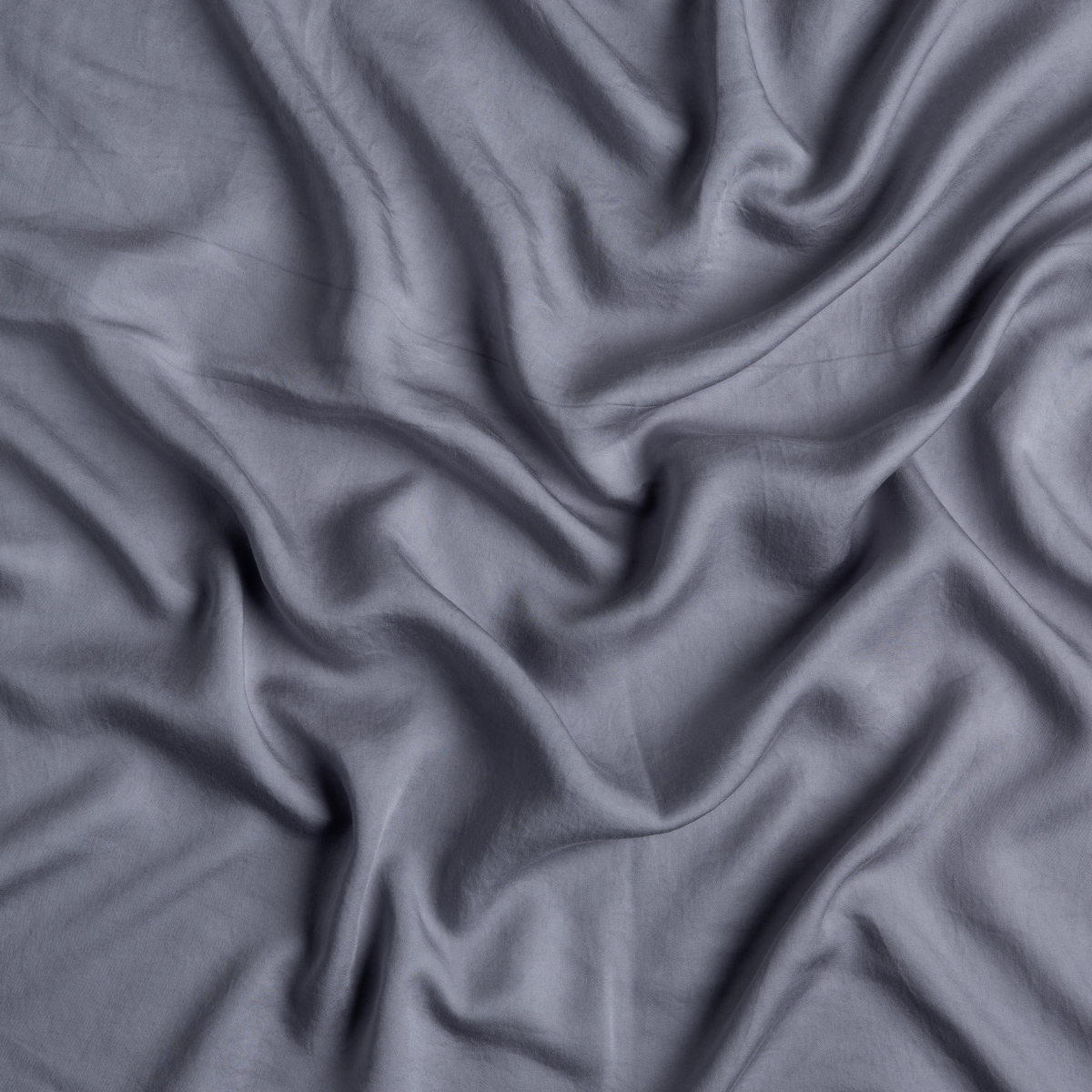 Close-up of draped French Lavender Madera Luxe fabric showing silky sheen and soft folds.
