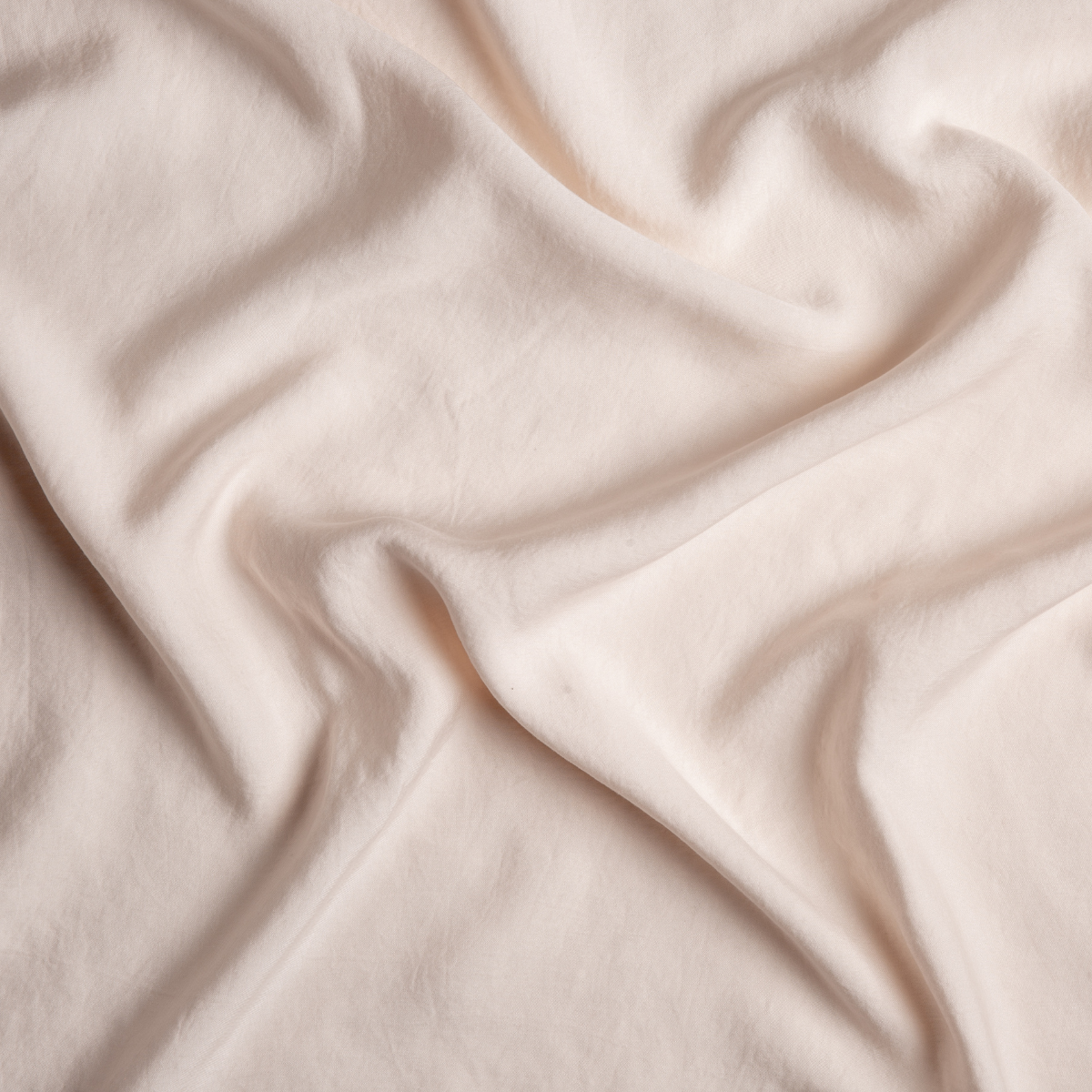 Draped Pearl Madera Luxe fabric showing soft sheen and smooth, flowing texture.