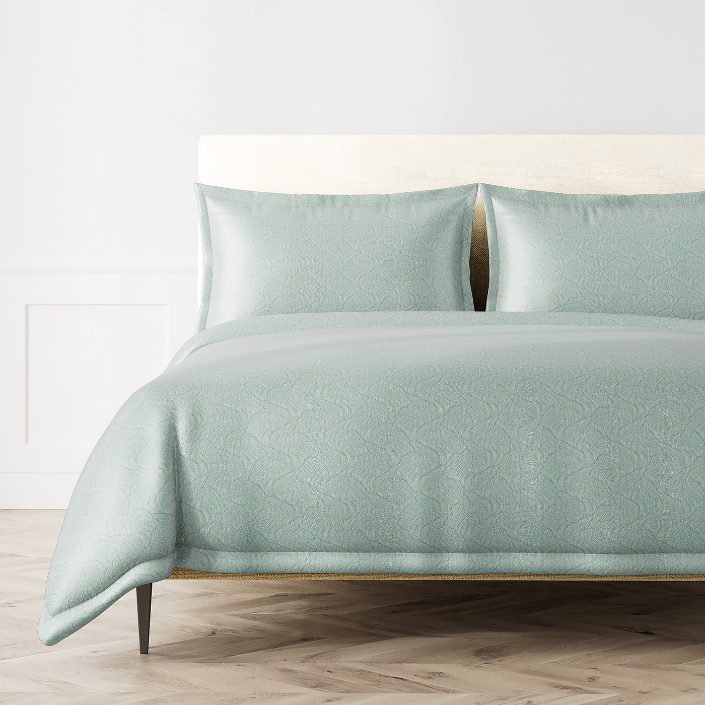 Ann Gish Tidal duvet set in seafoam with tone-on-tone scallop jacquard pattern, styled on bed.