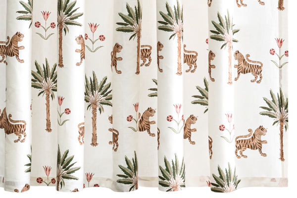 Curtains with a pattern of tigers, palm trees, and flowers on a white background