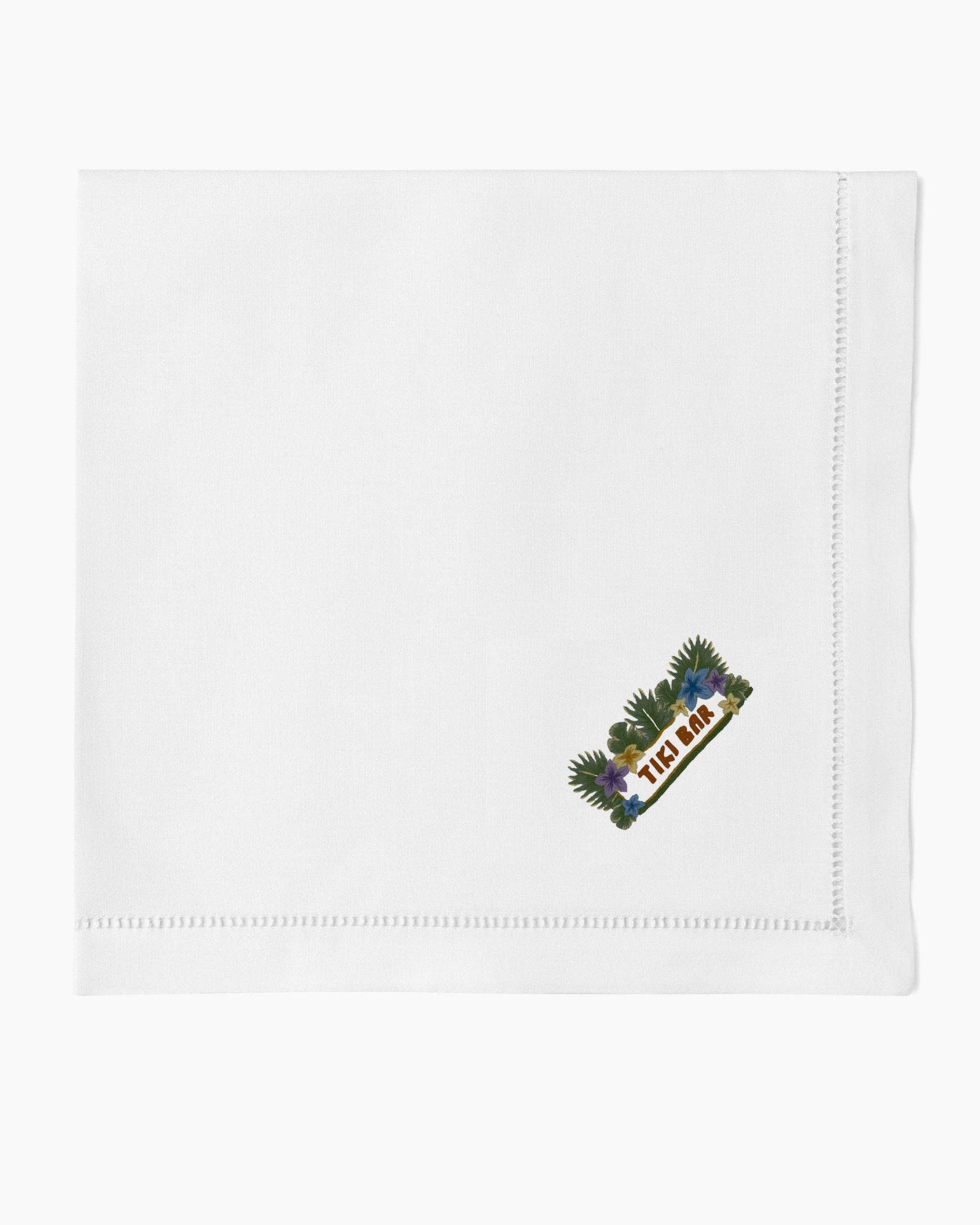 Henry Handwork white linen dinner napkin with embroidered Tiki Bar motif and hemstitch border.