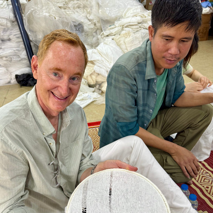 Tim O’Hearn, founder of Linen Society, seated with an embroiderer at the Henry Handwork workshop in Vietnam