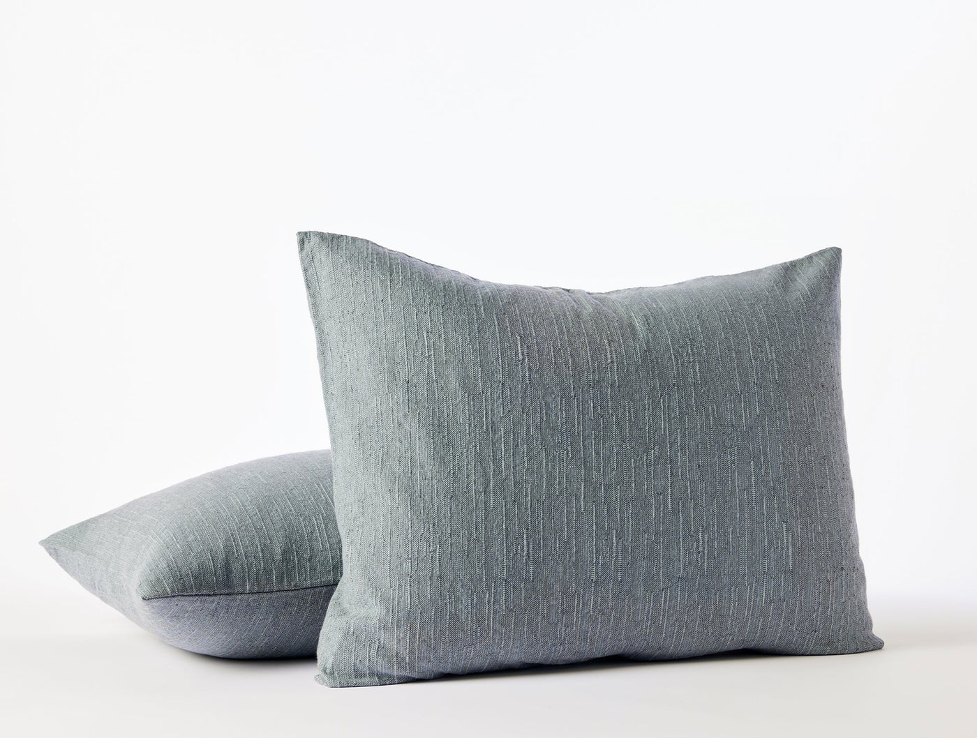 Two slate blue Coyuchi Toro Canyon shams stacked, showing subtle woven texture.
