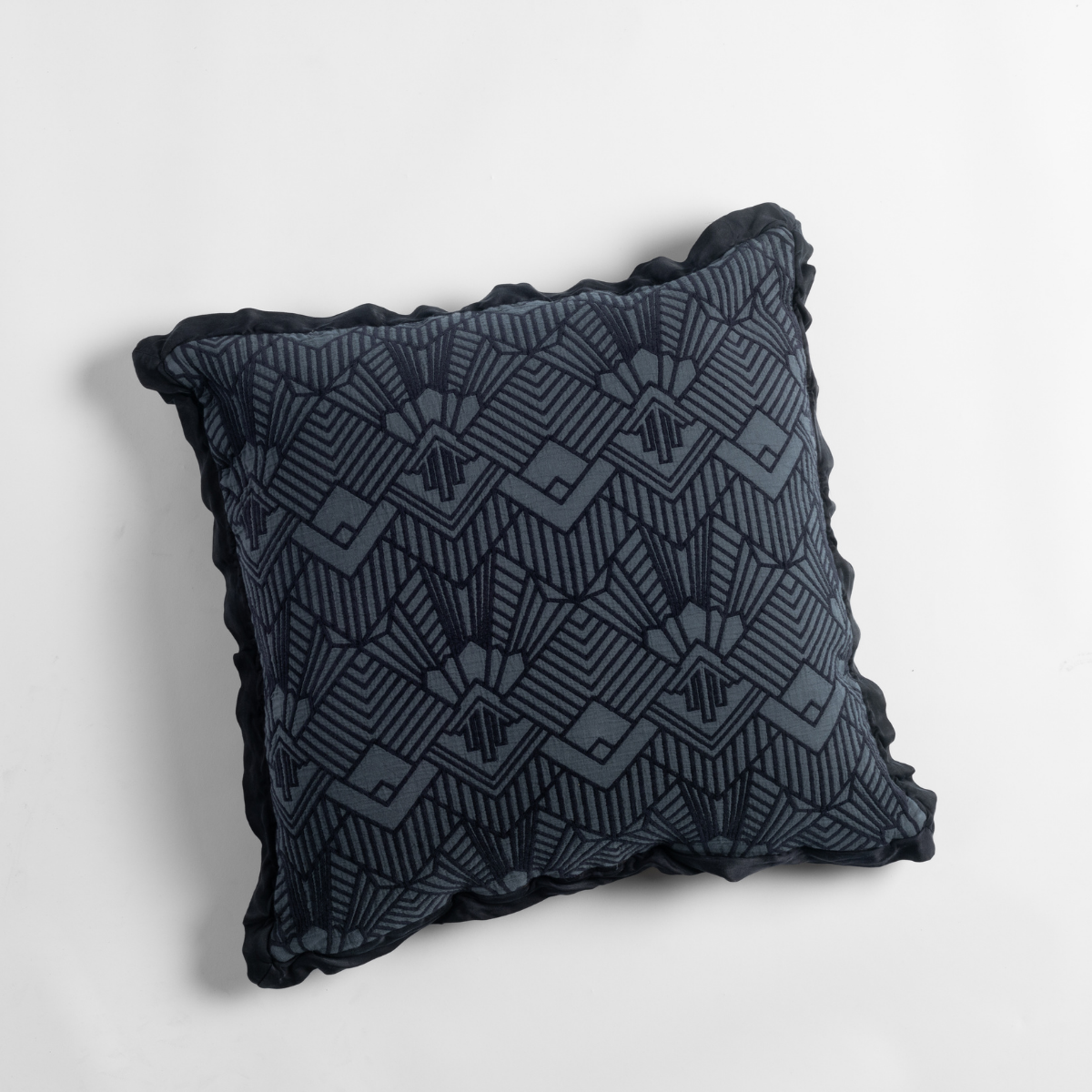 Slate Trettino throw pillow close-up showing Art Deco geometric embroidery and scalloped trim.