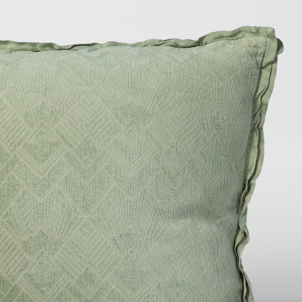 Close-up of Desert Sage sham corner showing diamond jacquard weave and ruffled edge trim.