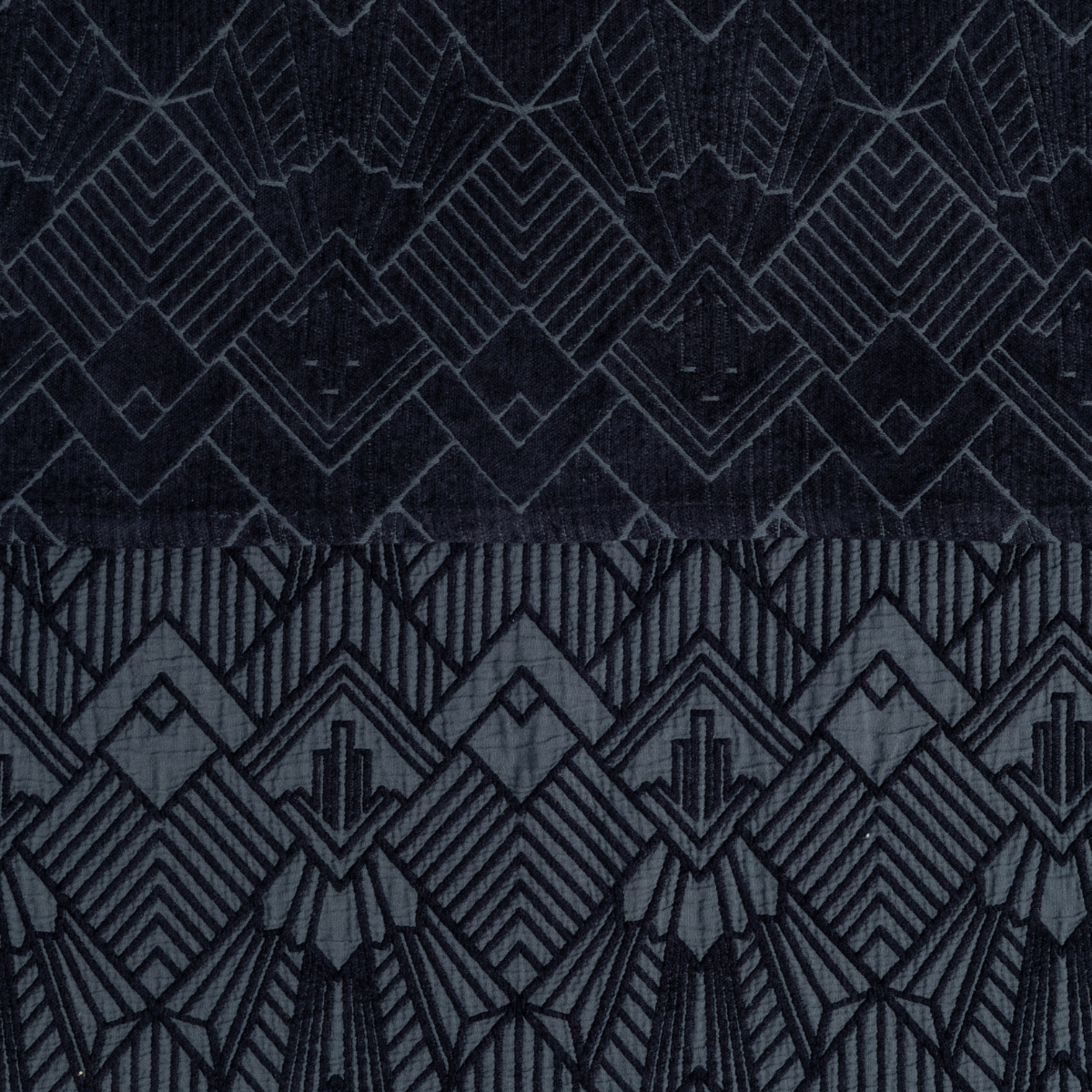 Close-up of Bella Notte Trettino in Slate, showing Art Deco geometric embroidery on dark fabric.
