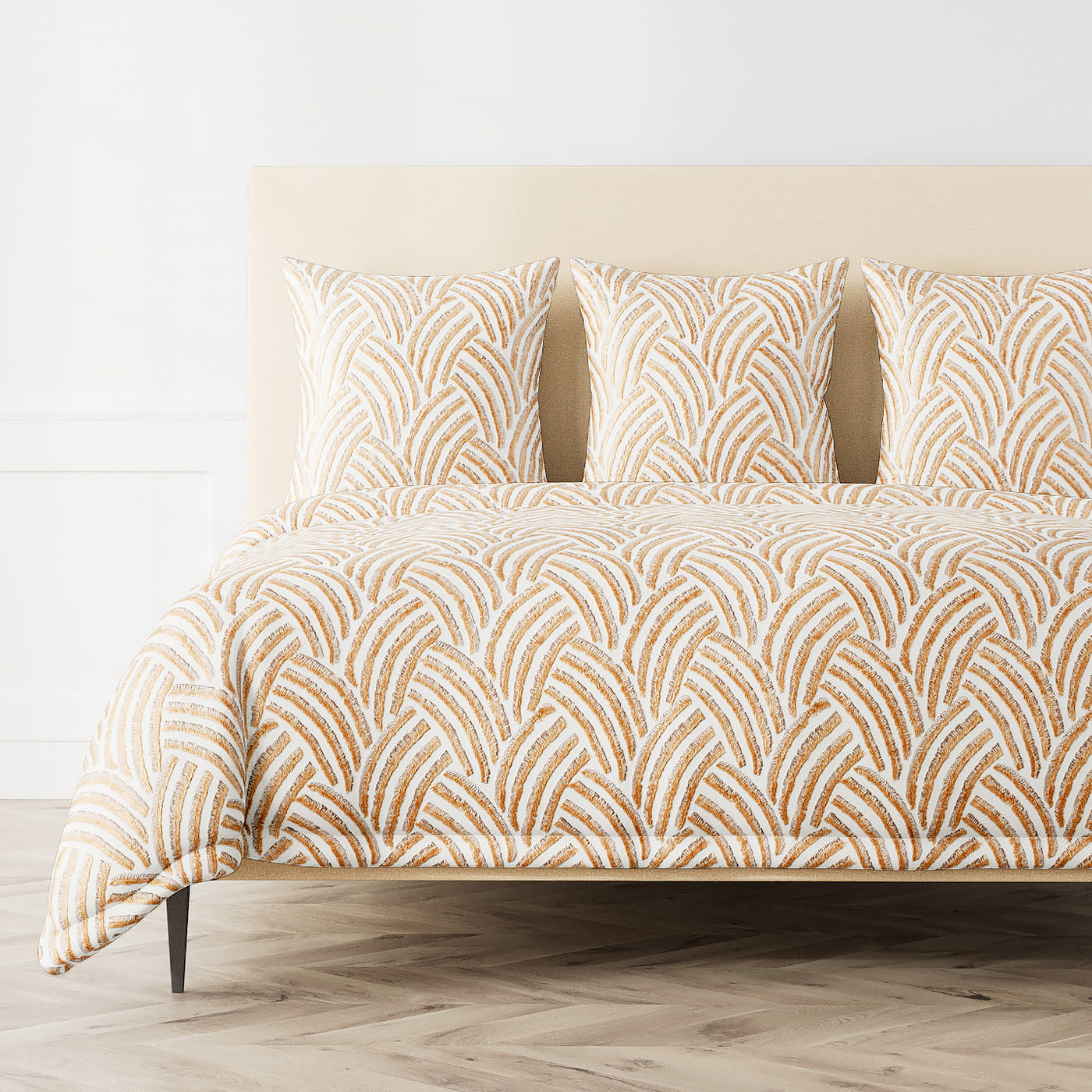 Ann Gish Trevi duvet cover in amber and ivory arched mosaic pattern on styled bed.