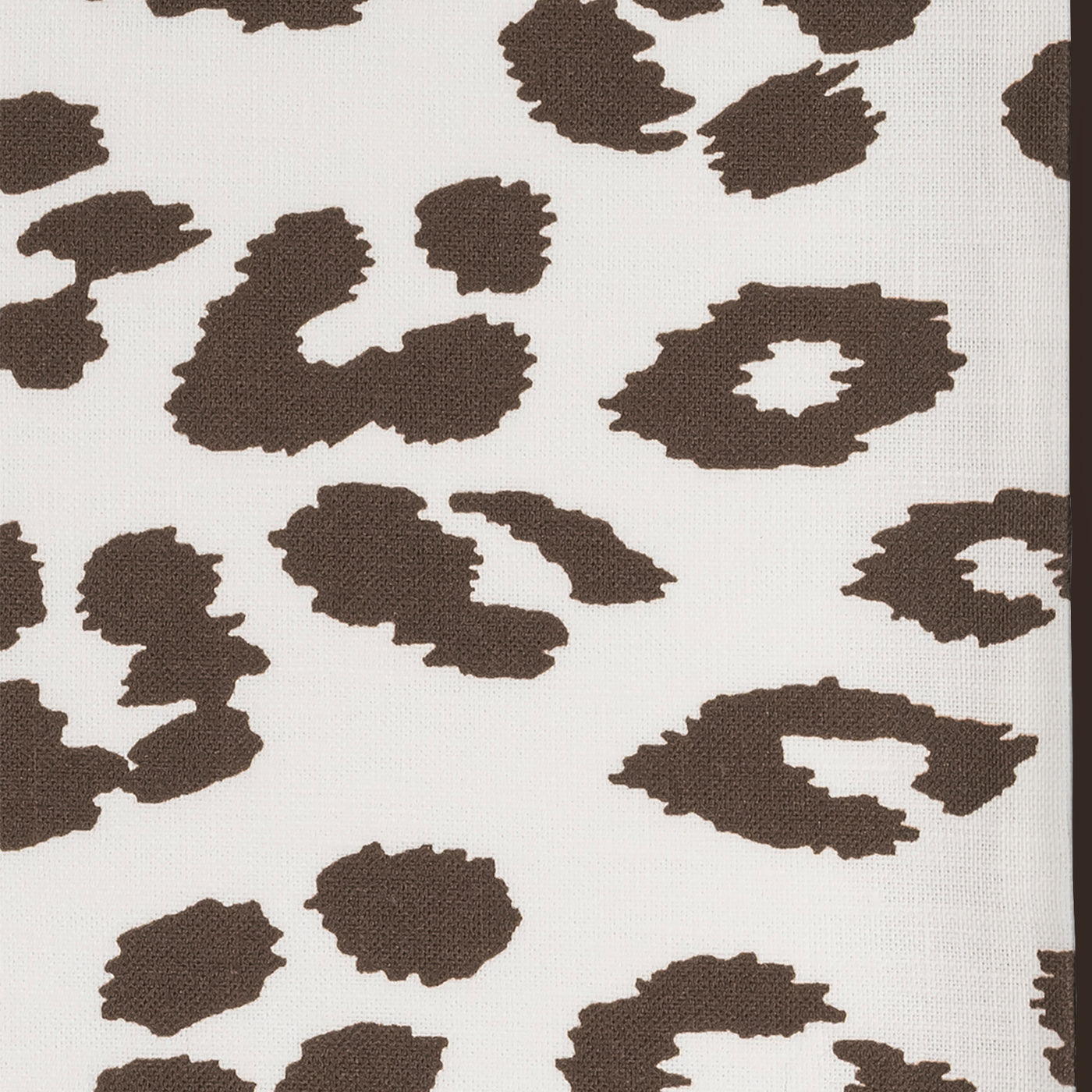 Close-up of ivory linen with chocolate leopard-print jacquard weave pattern.