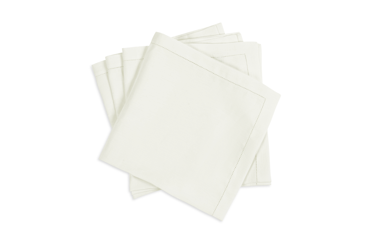 The Valentina Hemstitch Napkin Set by Matouk features four neatly stacked white cloth napkins with elegant hemstitch borders—an ideal choice for enhancing any luxurious tabletop collection.