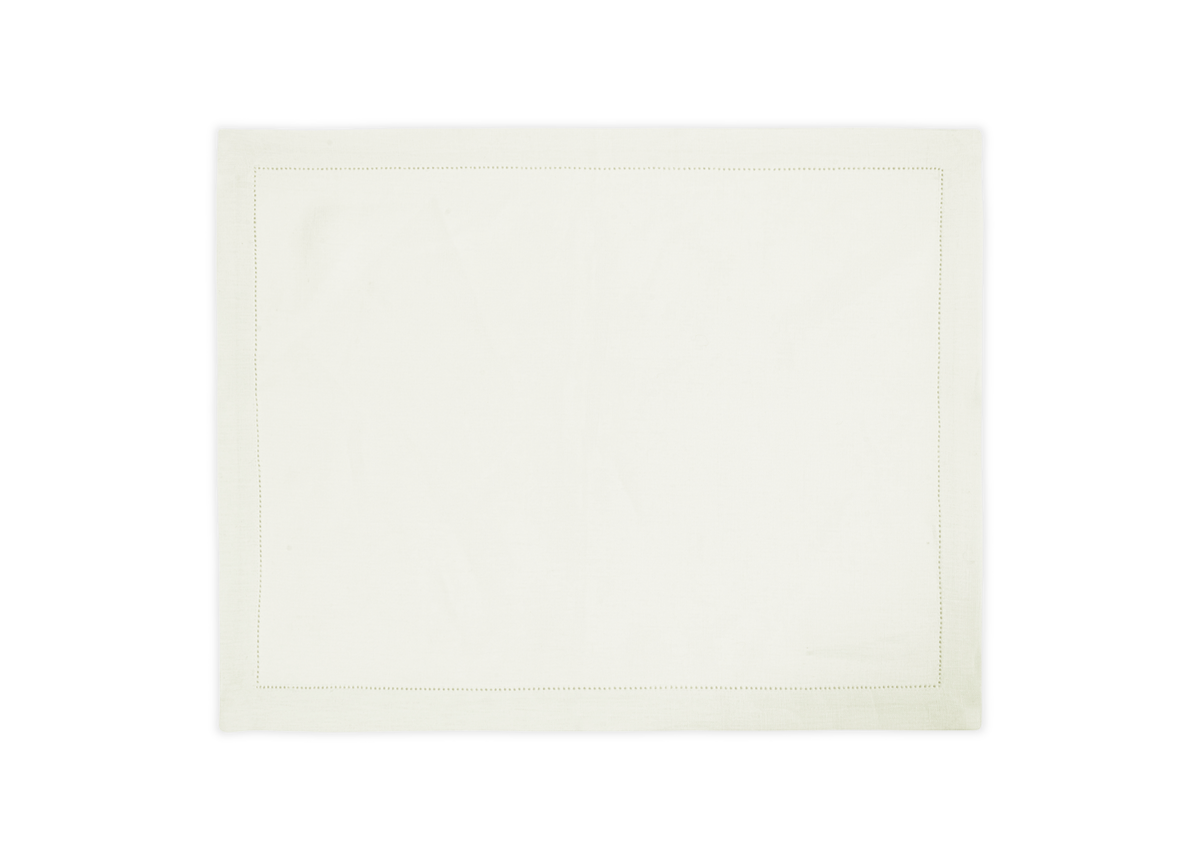 The Matouk Valentina Hemstitch Placemat Set features rectangular white placemats with folded edges, subtle stitching, and a hemstitch border, shown laid flat on a white background.