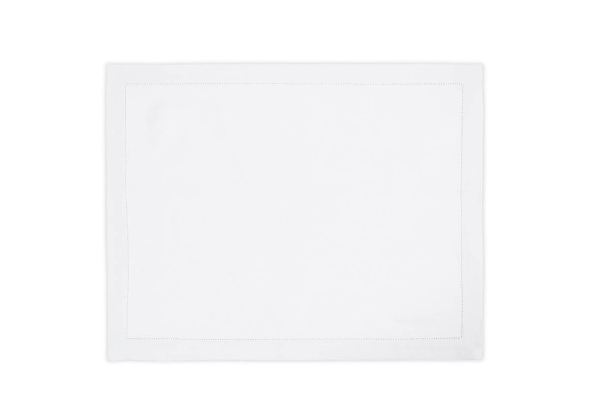 The Valentina Hemstitch Placemat Set by Matouk features rectangular white linen placemats with a hemstitch border, shown on a white background.