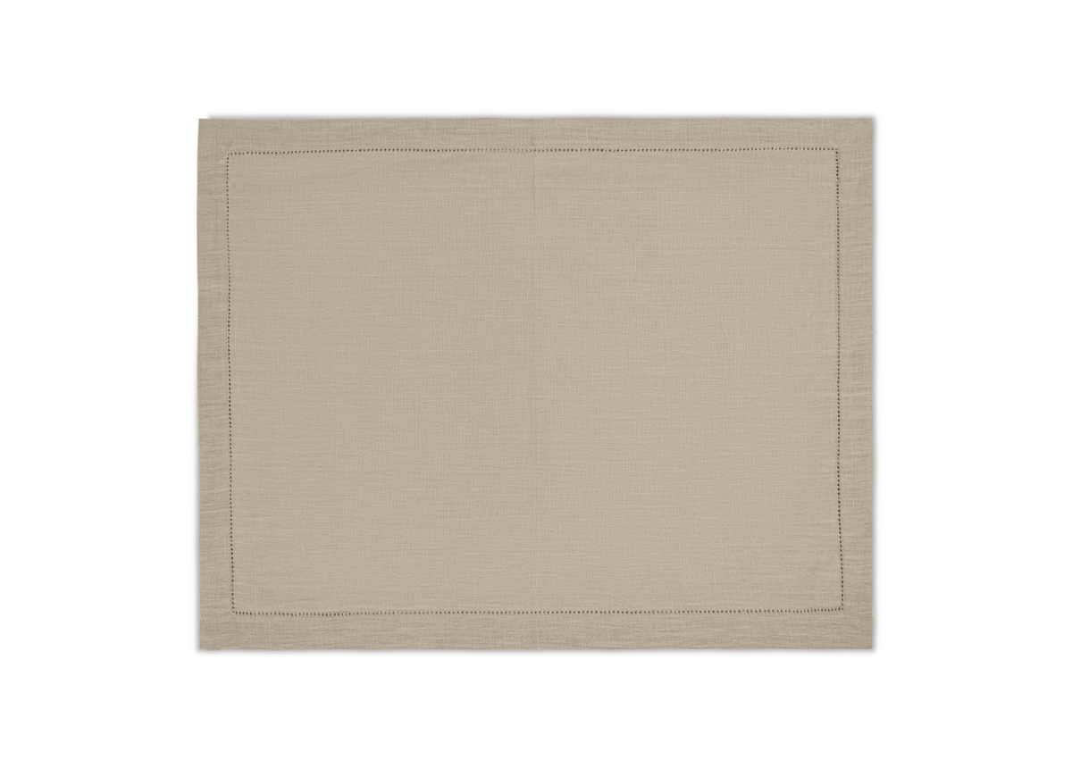 The Valentina Hemstitch Placemat Set by Matouk, crafted from luxurious beige linen with a delicate hemstitch border, is shown flat on a white background.