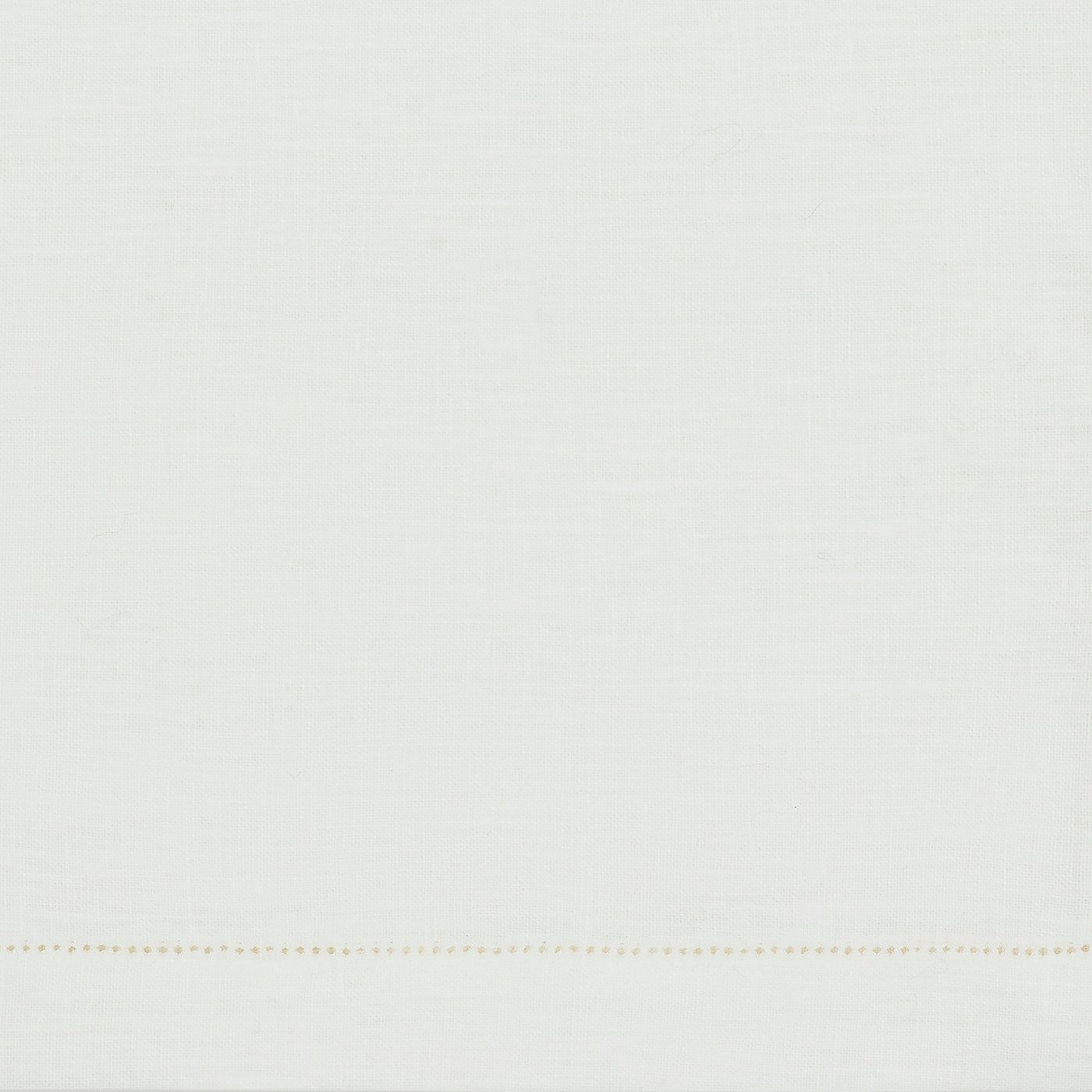 The Valentina Hemstitch Cocktail Napkin Set by Matouk features sumptuous white linen with a subtle woven texture and a single line of small, evenly spaced yellow stitches near the bottom edge—a refined tabletop accent.