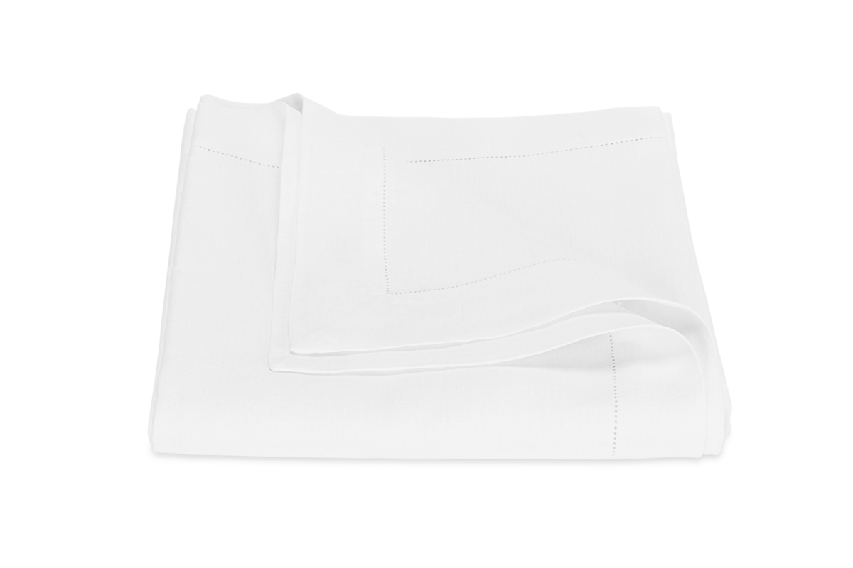 The Matouk Valentina Hemstitch Tablecloth, neatly folded, features elegant hemstitch border detailing on a plain white background.