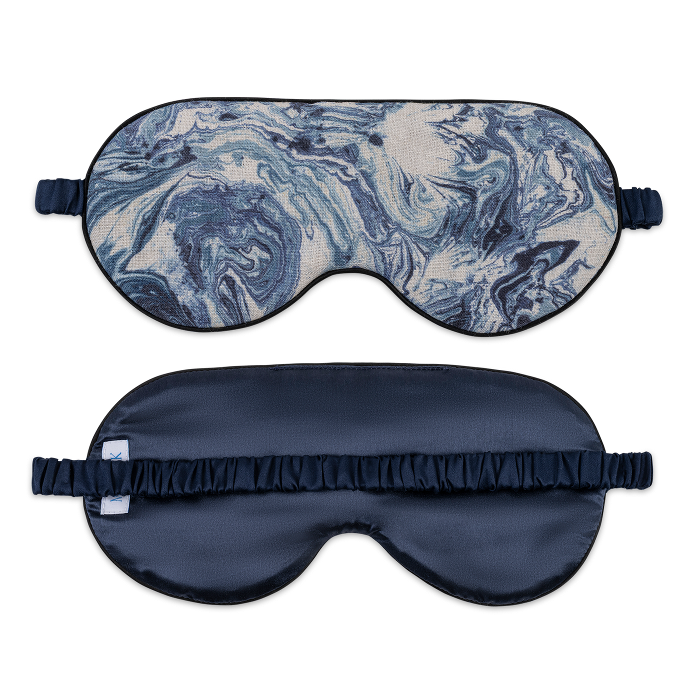 Reversible Matouk Valentina sleep mask showing navy marble print front and solid navy silk reverse.